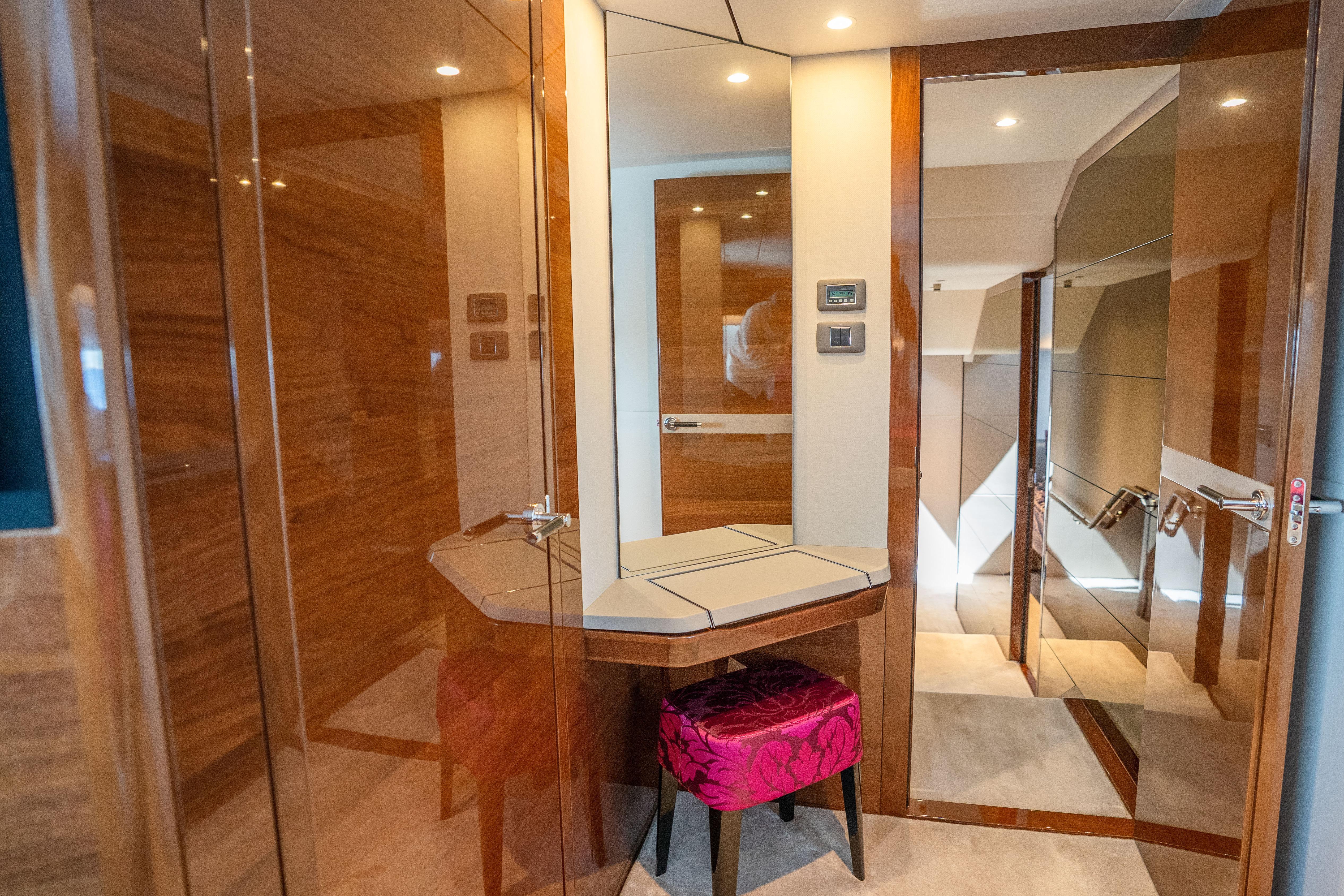 Luxurious interior of 2020 Princess Y85 yacht with elegant wood paneling and plush seating.
