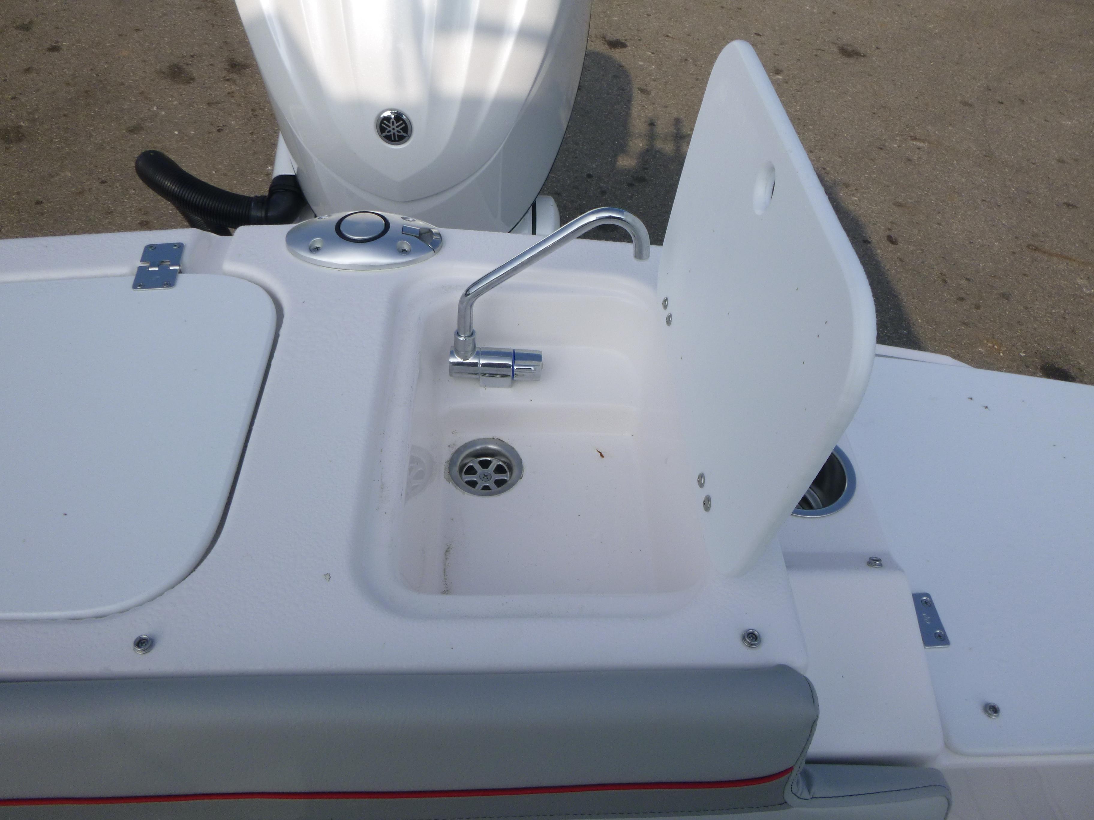 Compact sink on Solara S-250 CW boat, 2025 model, with faucet and drain.