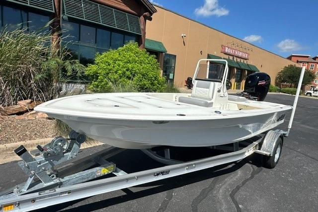 2026 Mako 18 Pro Skiff on trailer, parked outside a boat service center.