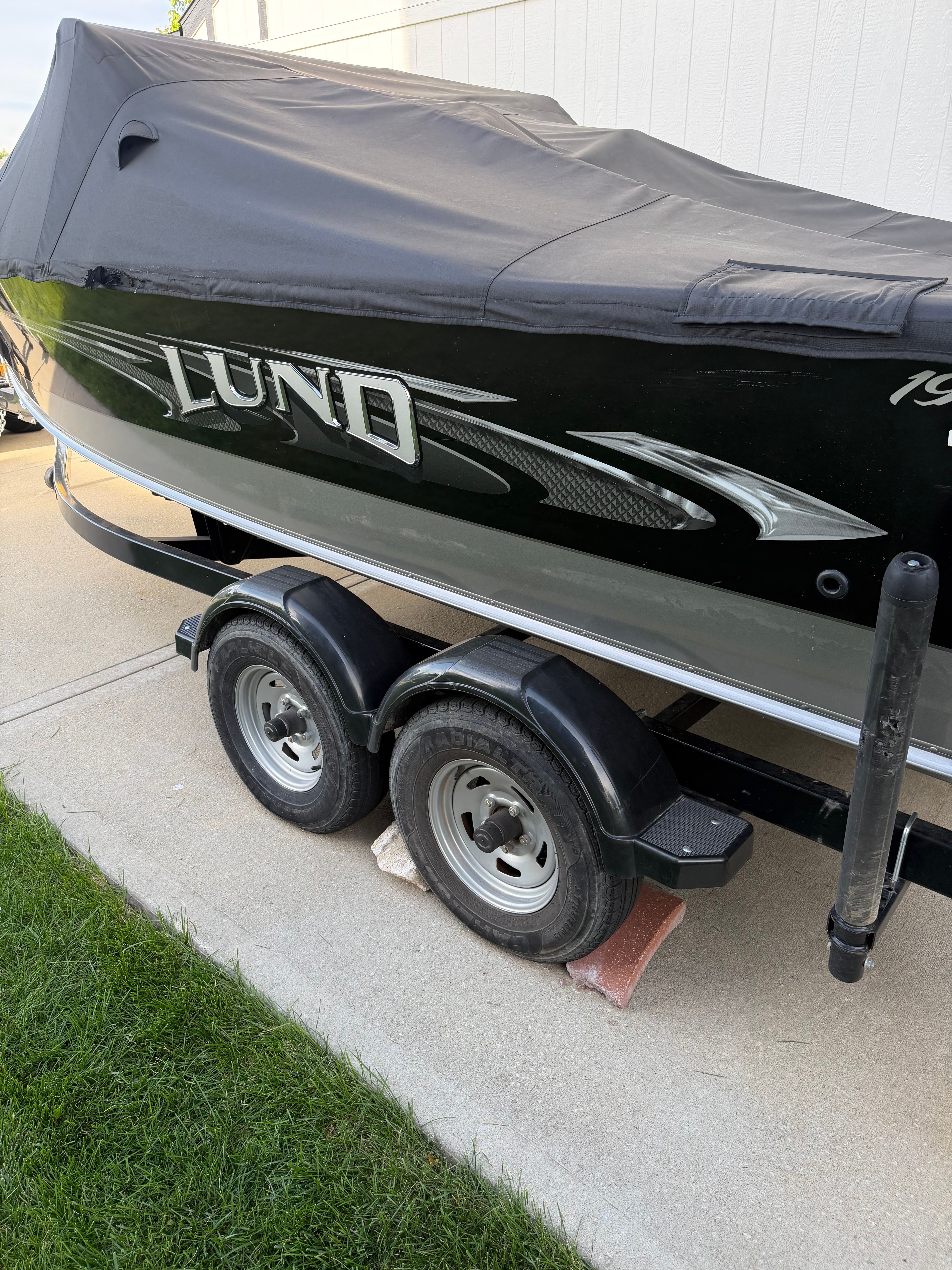2017 Lund Pro V 1975 boat on trailer covered.