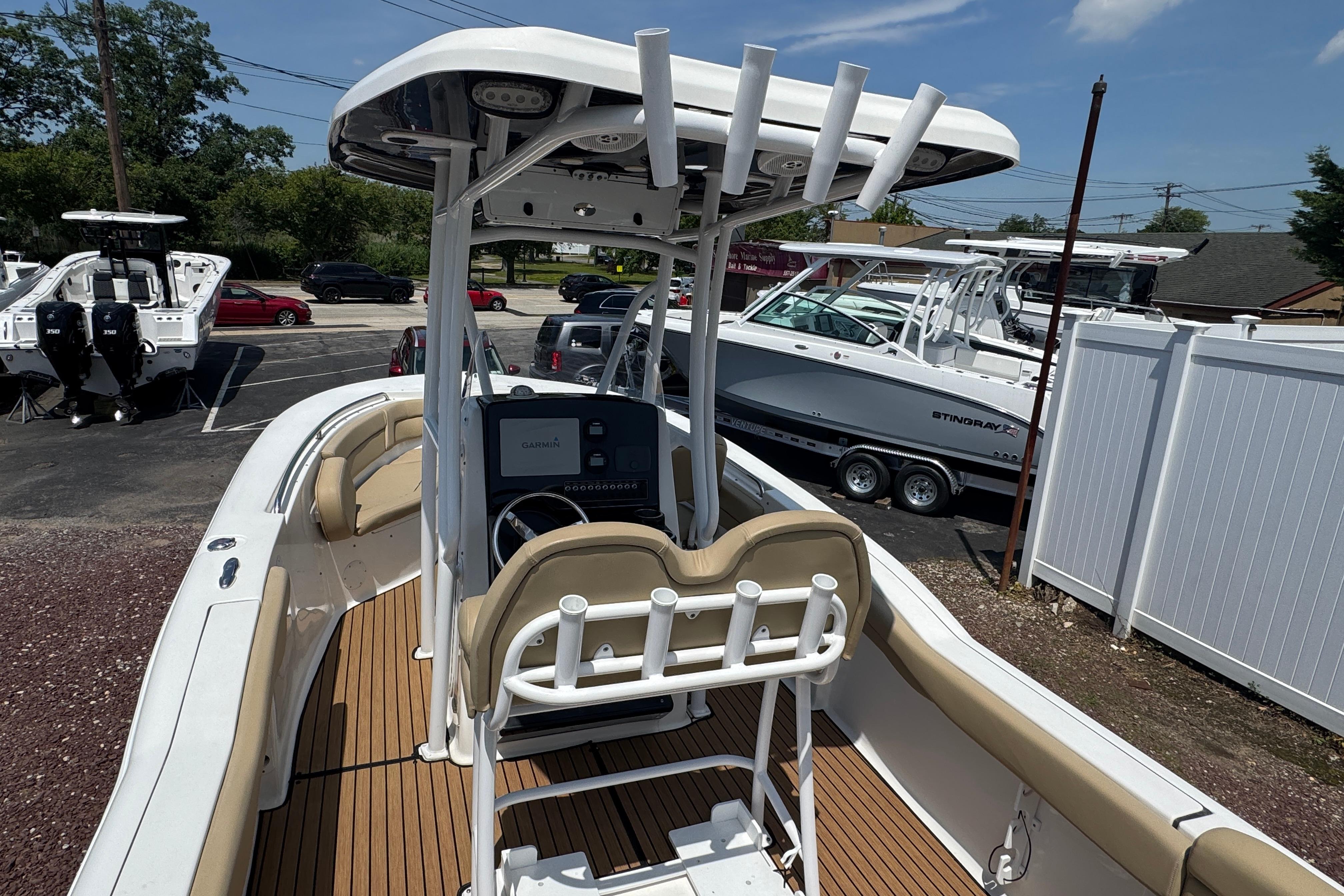 2016 Tidewater 230 LXF boat with center console and seating, displayed outdoors.