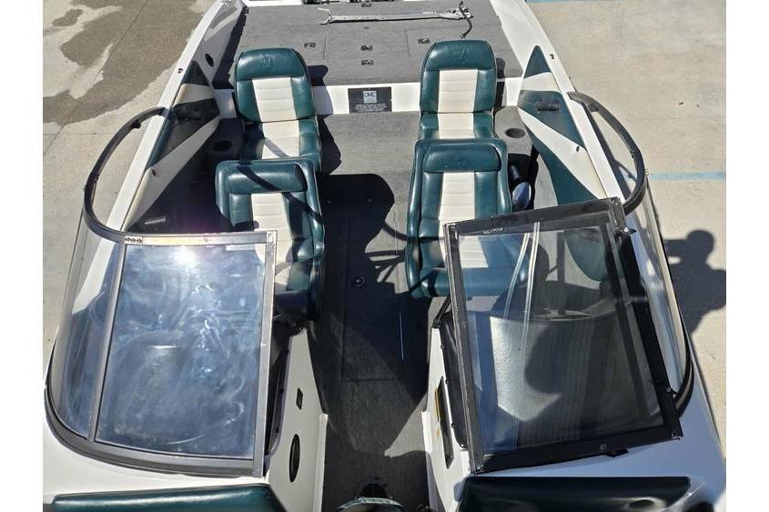 1997 Javelin 389 FS boat interior with dual green and white seats, open windshield.