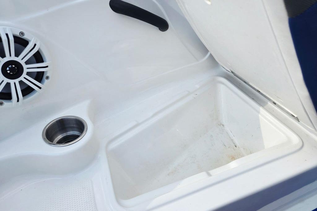 Interior of 2018 Tahoe 450 TS boat showing speaker and storage compartment.