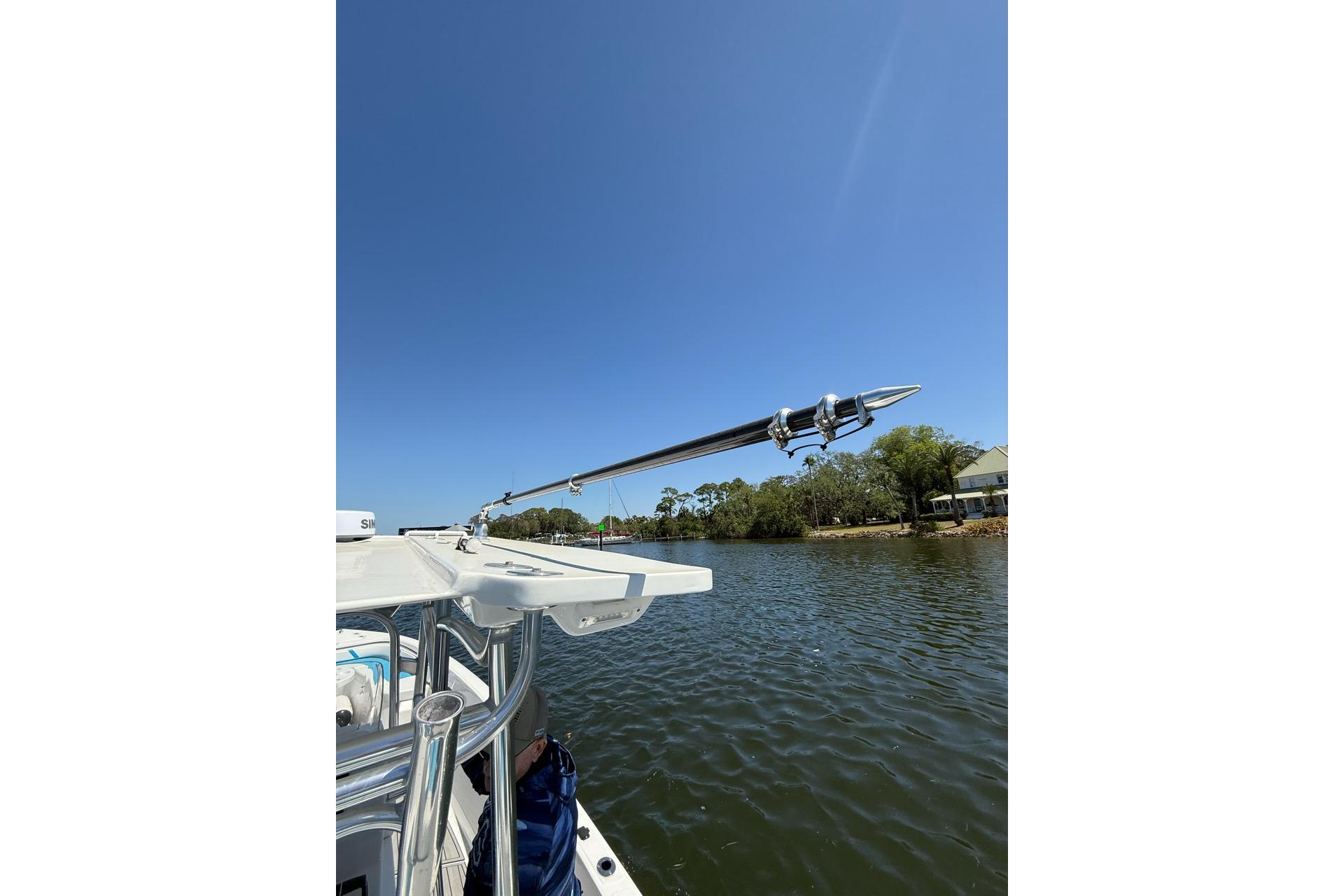 Custom Infusion 34 CC boat on a sunny day, 2021 model, near a calm riverbank.