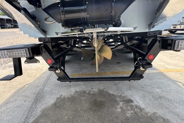 Rear view of 2026 MasterCraft XStar 25 boat showing propeller and trailer.