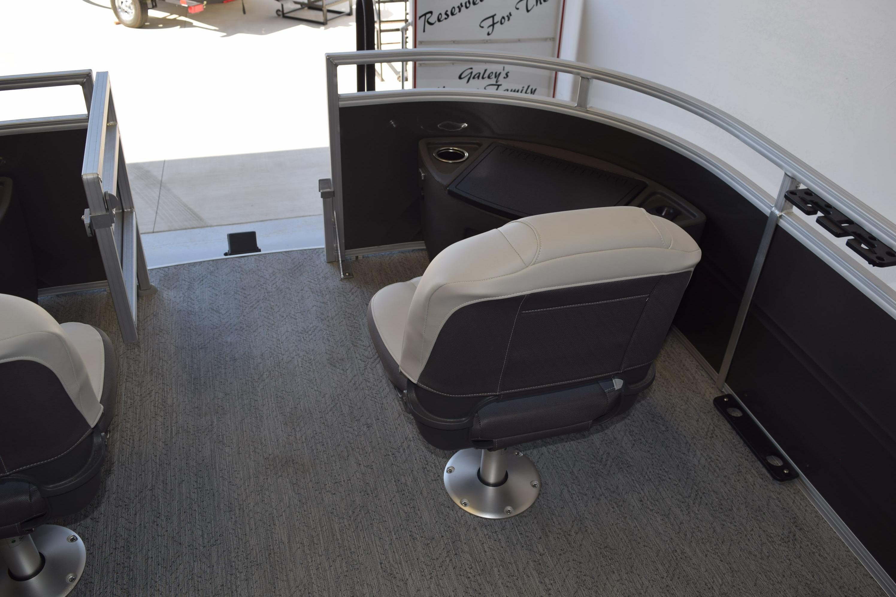 2026 Sun Tracker Fishin' Barge 22 DLX interior with seating and railing.