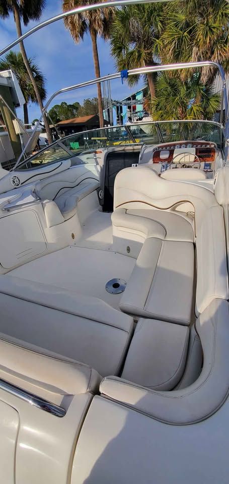 The image shows the cockpit of a 2002 Wellcraft 3300 Martinique with white upholstery.