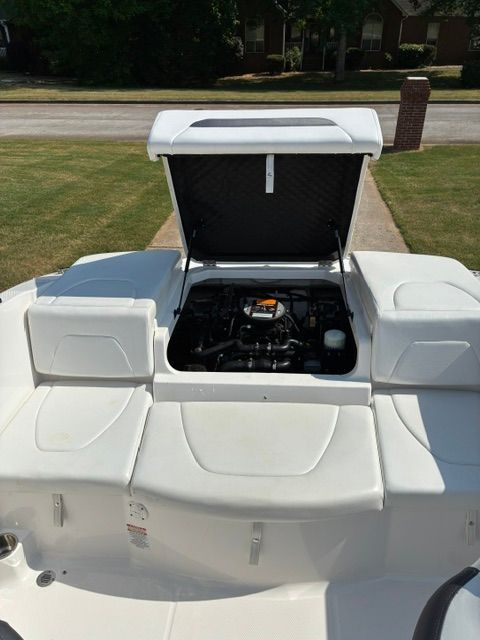 A 2012 Chaparral 19 H2O Sport with an open engine compartment on a trailer.