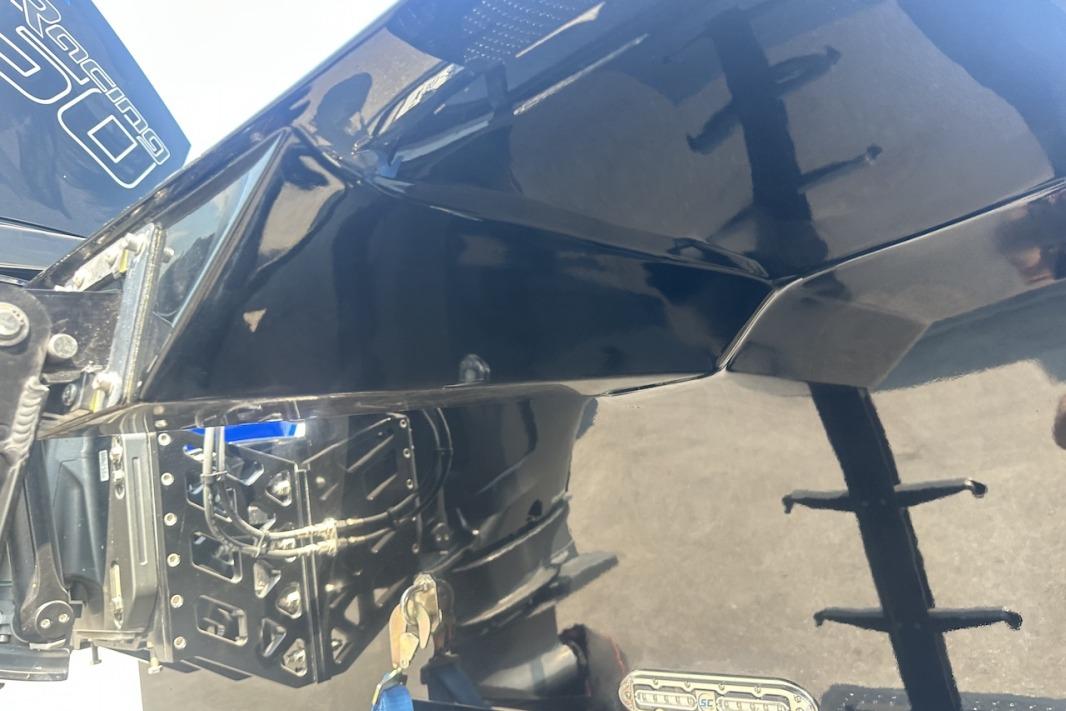 Close-up of a 2018 Wright Performance 420 boat's sleek black hull and engine components.
