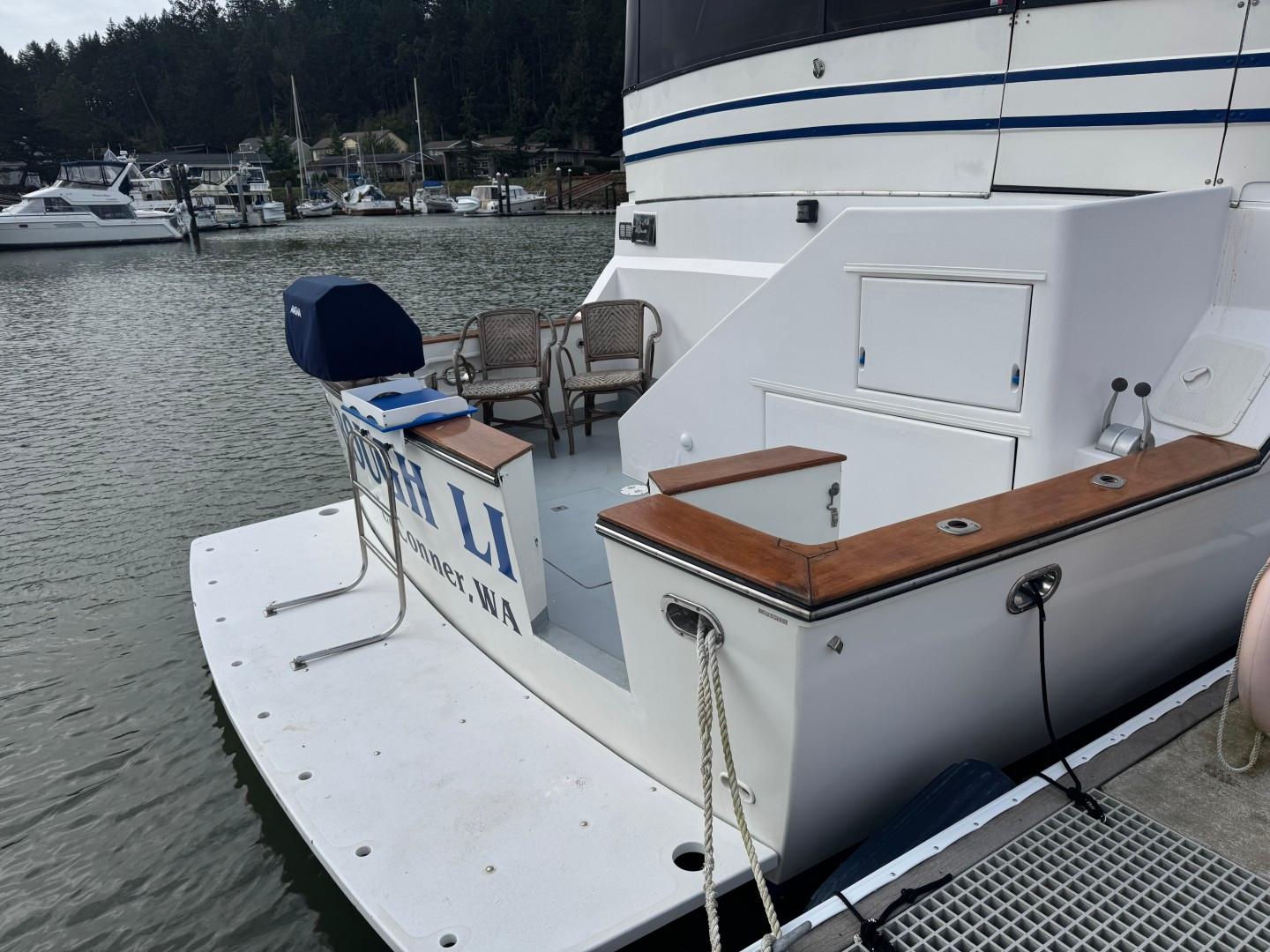 1989 Prima 52 Cockpit Motor Yacht docked, featuring spacious deck and seating area.
