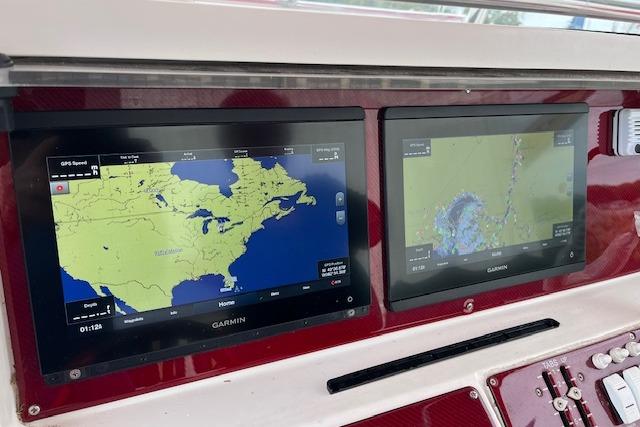 Garmin navigation screens on a 2001 Fountain 38 Center Console boat dashboard.