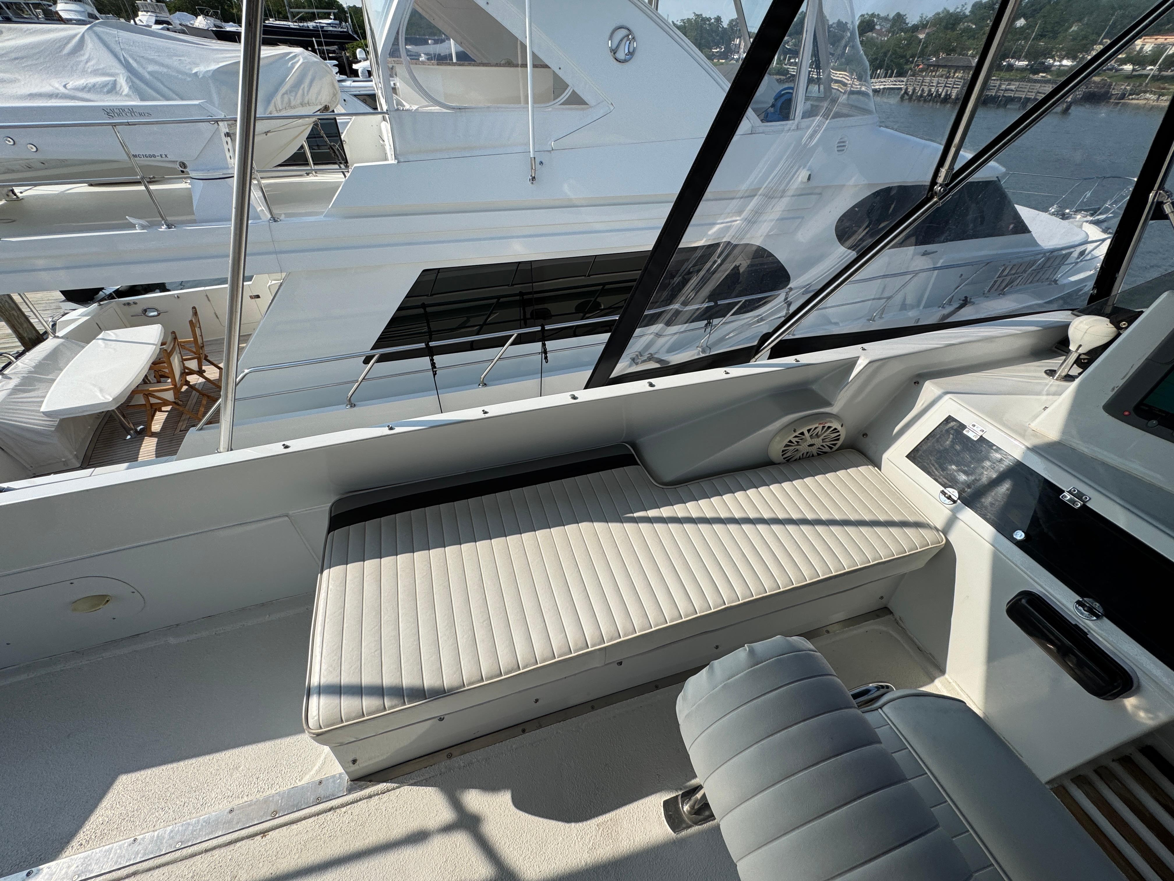 1989 Birchwood 62 Cockpit Motor Yacht interior with cushioned seating and sleek design.