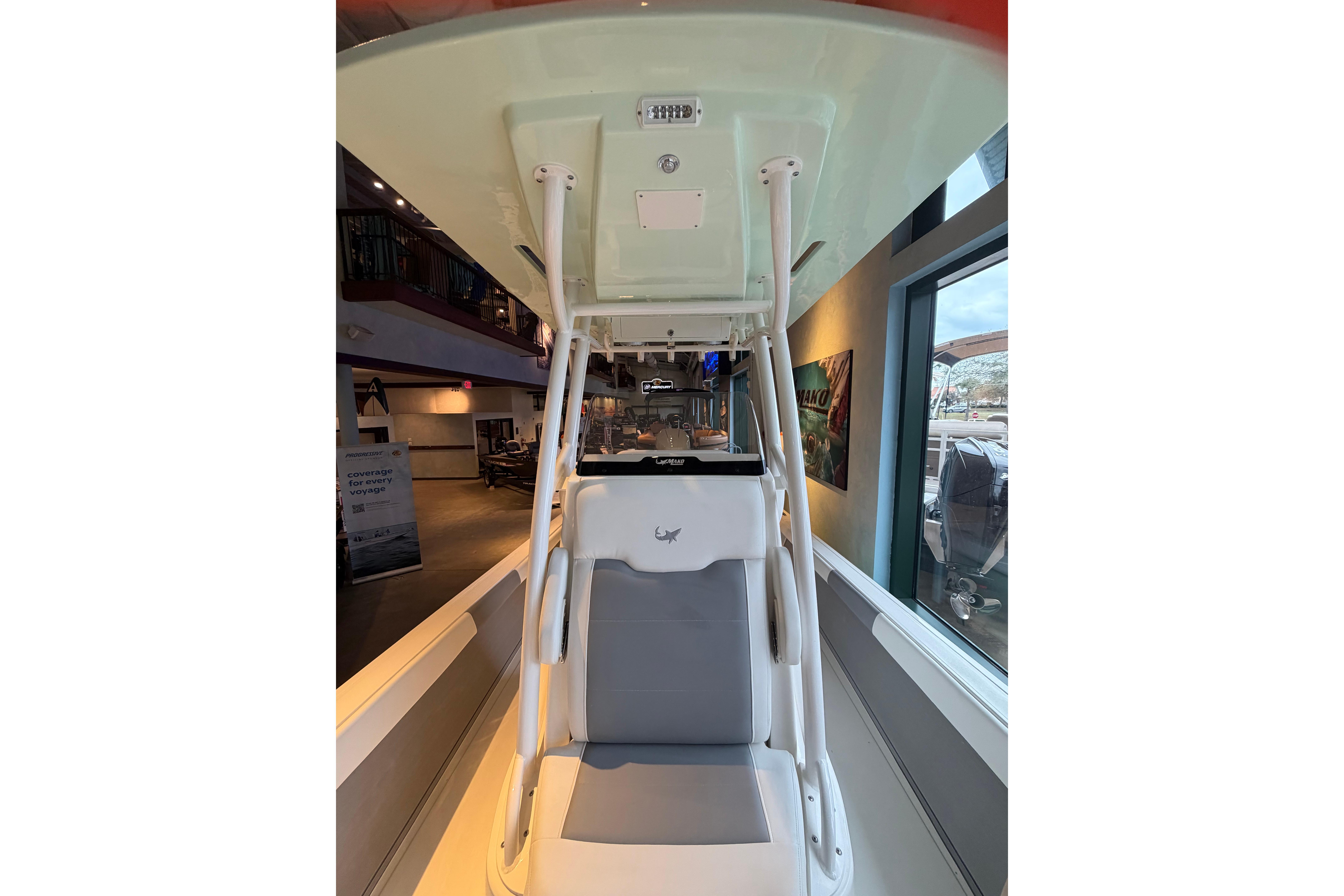 2026 Mako 24 APEX boat interior with seating and overhead structure.