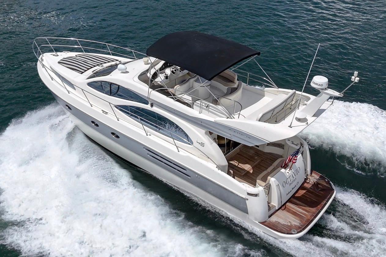 2004 Azimut 46 yacht cruising on open water, featuring sleek design and spacious deck.