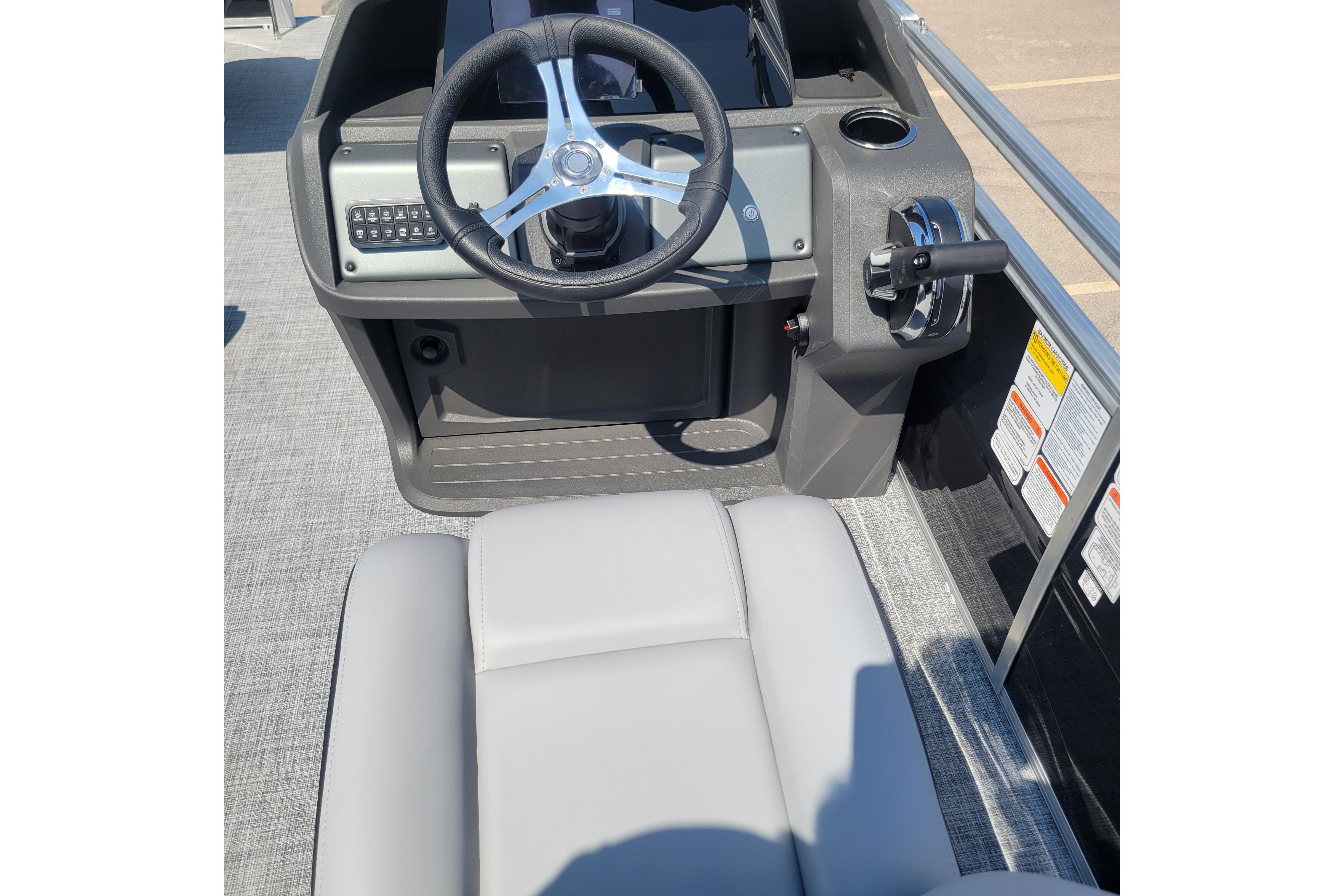 2026 Sun Tracker SportFish 20 DLX boat helm with steering wheel and controls.