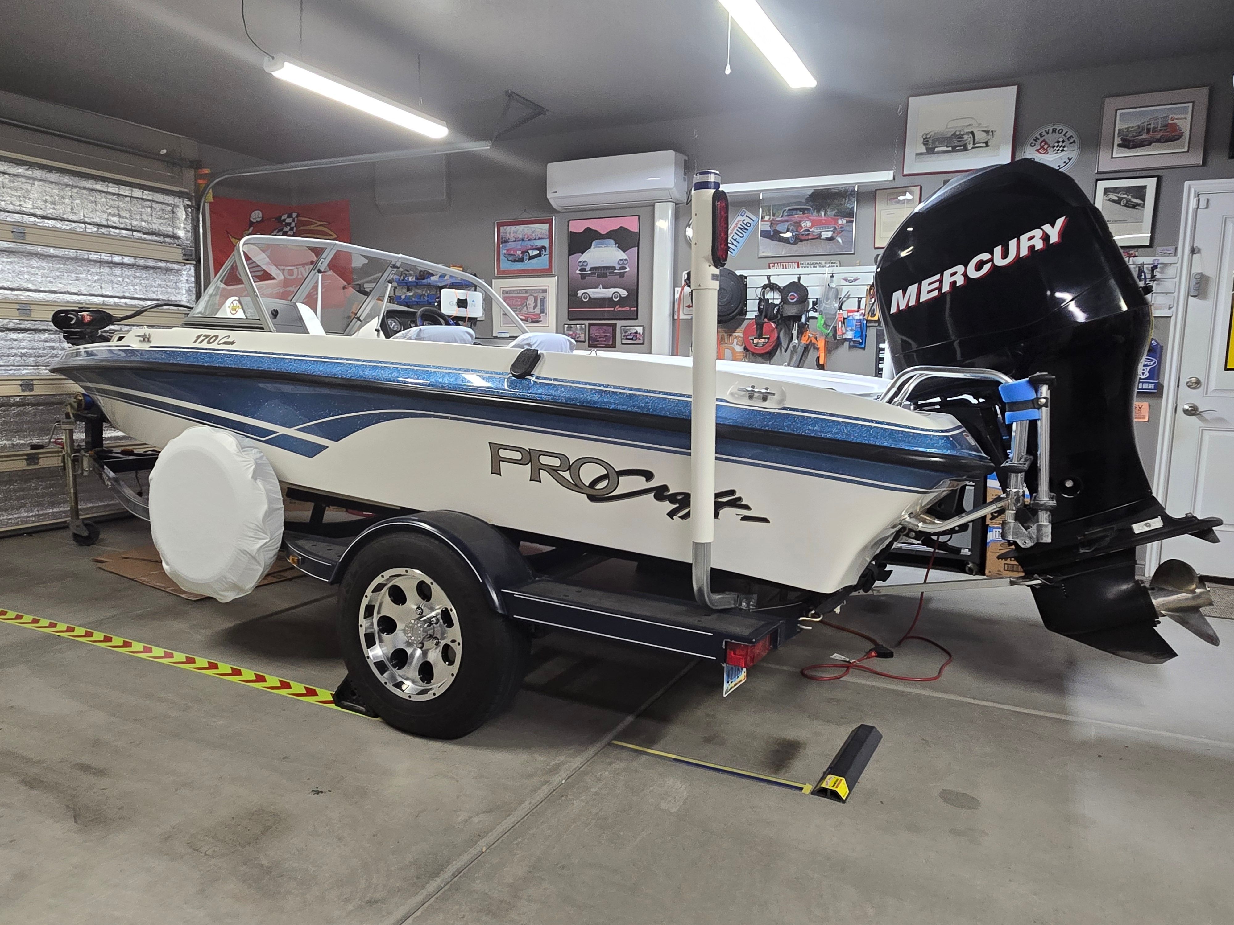 2007 ProCraft 170 Combo in a garage, featuring a Mercury outboard motor.