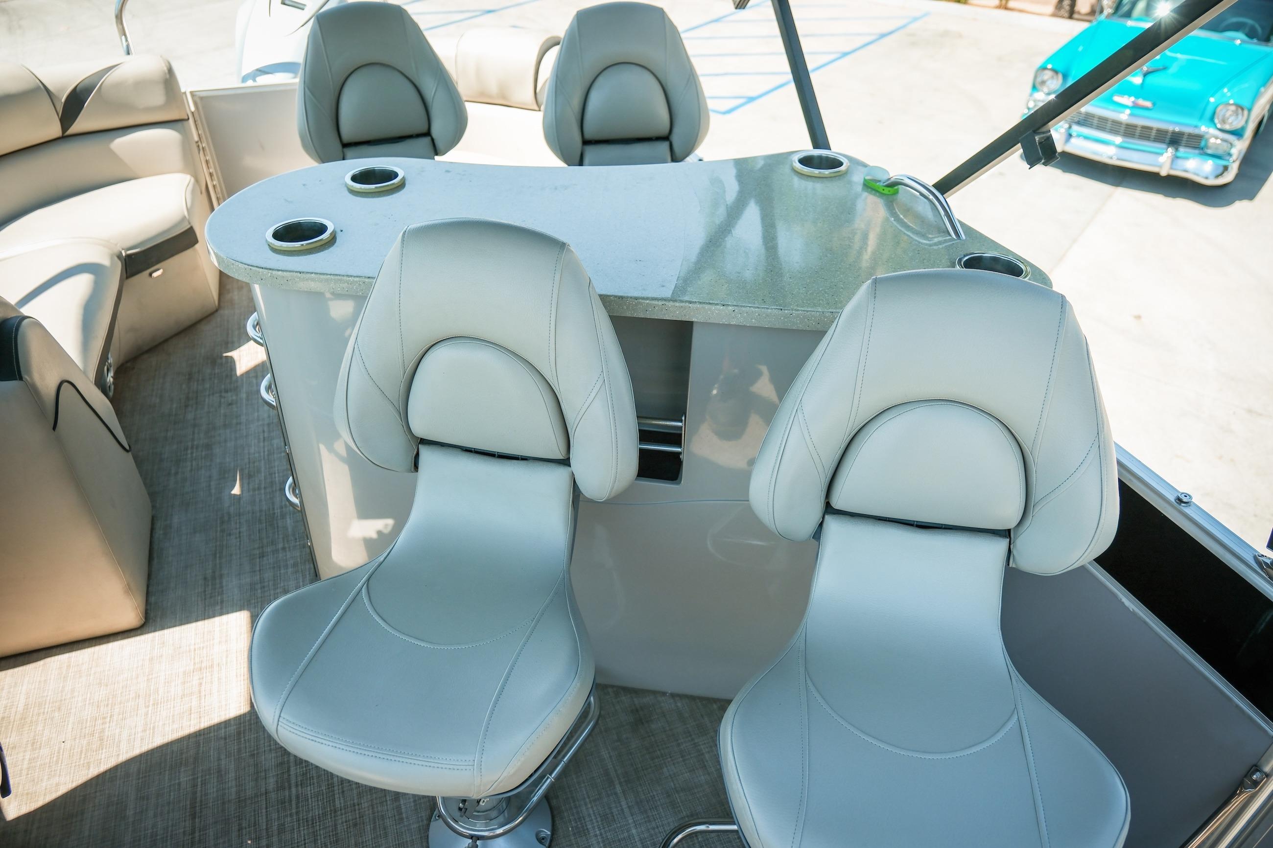 Interior of 2019 Berkshire 25CLE STS pontoon boat with plush seating and table.