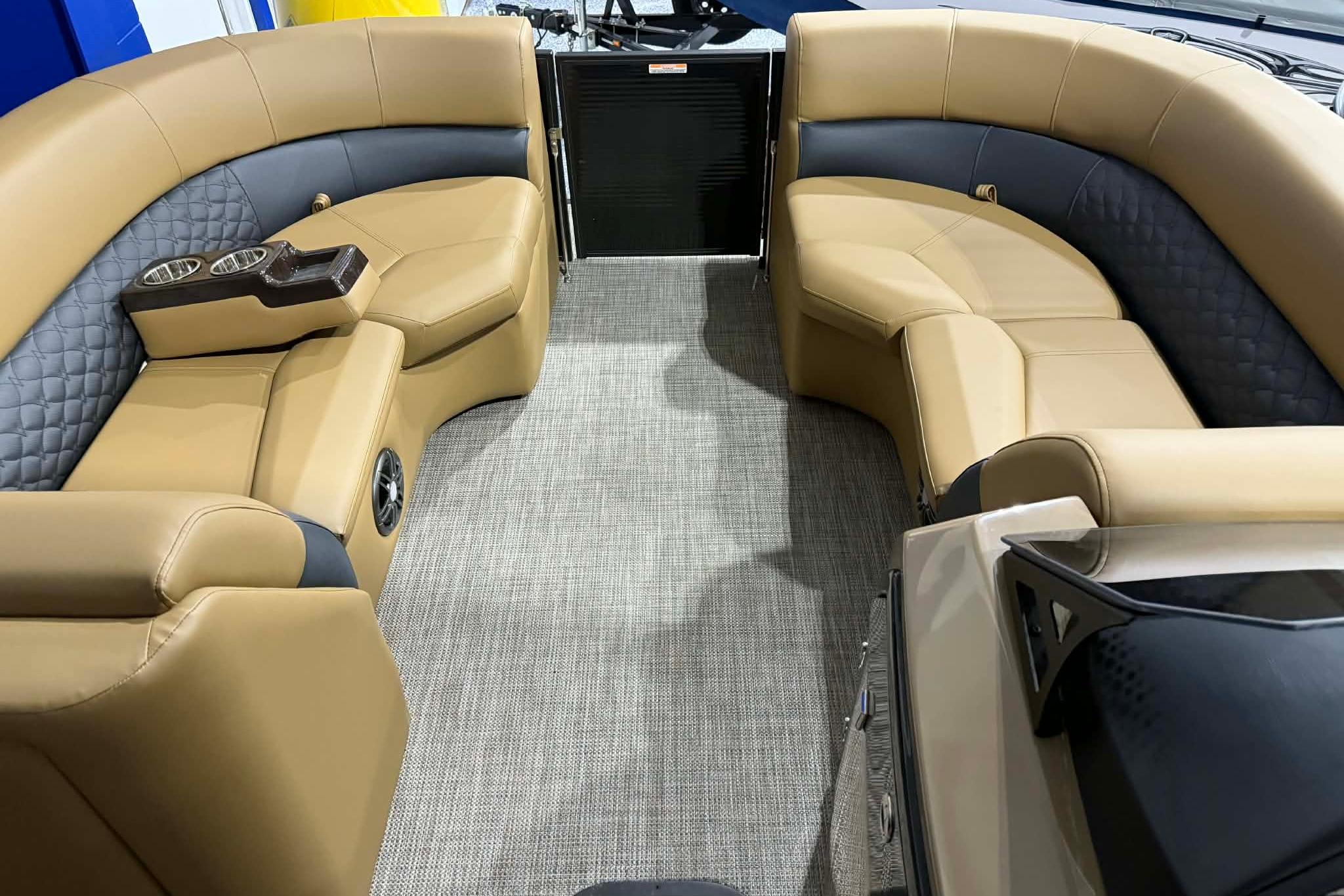 Luxurious interior of 2026 Manitou Encore VP 230 pontoon boat with plush seating.