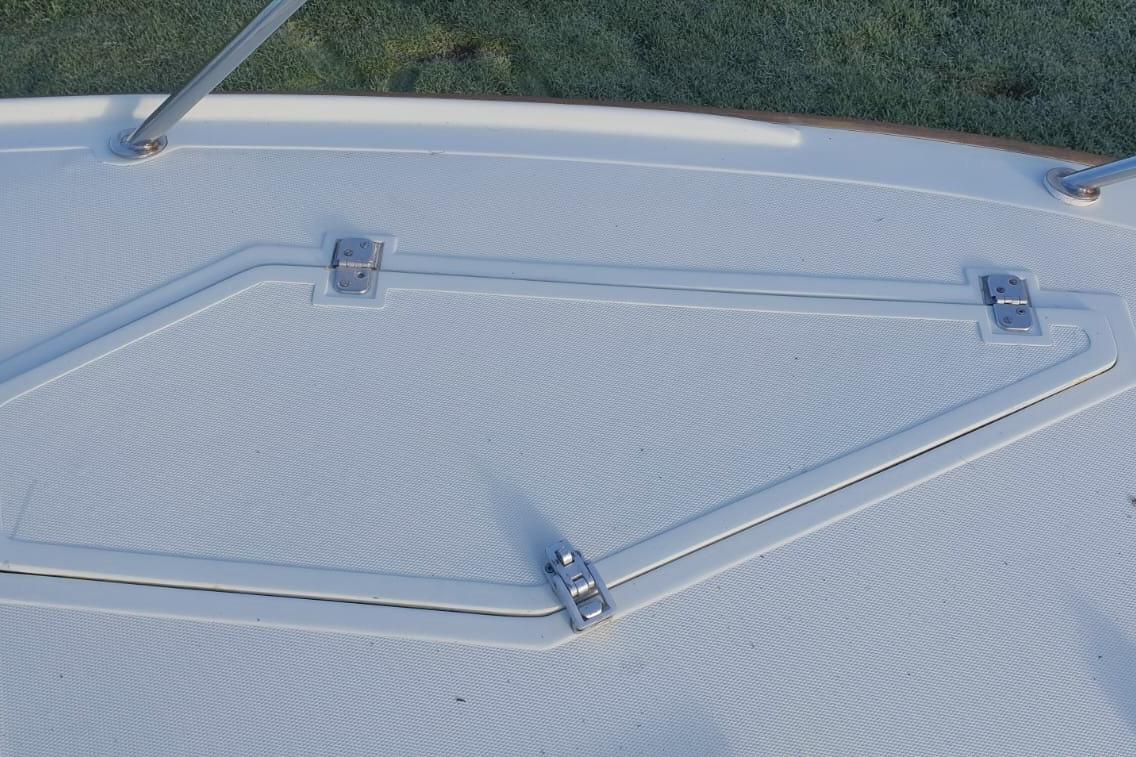 Hatch cover on 1989 Fairey Spearfish MKIII boat deck with metal hinges.