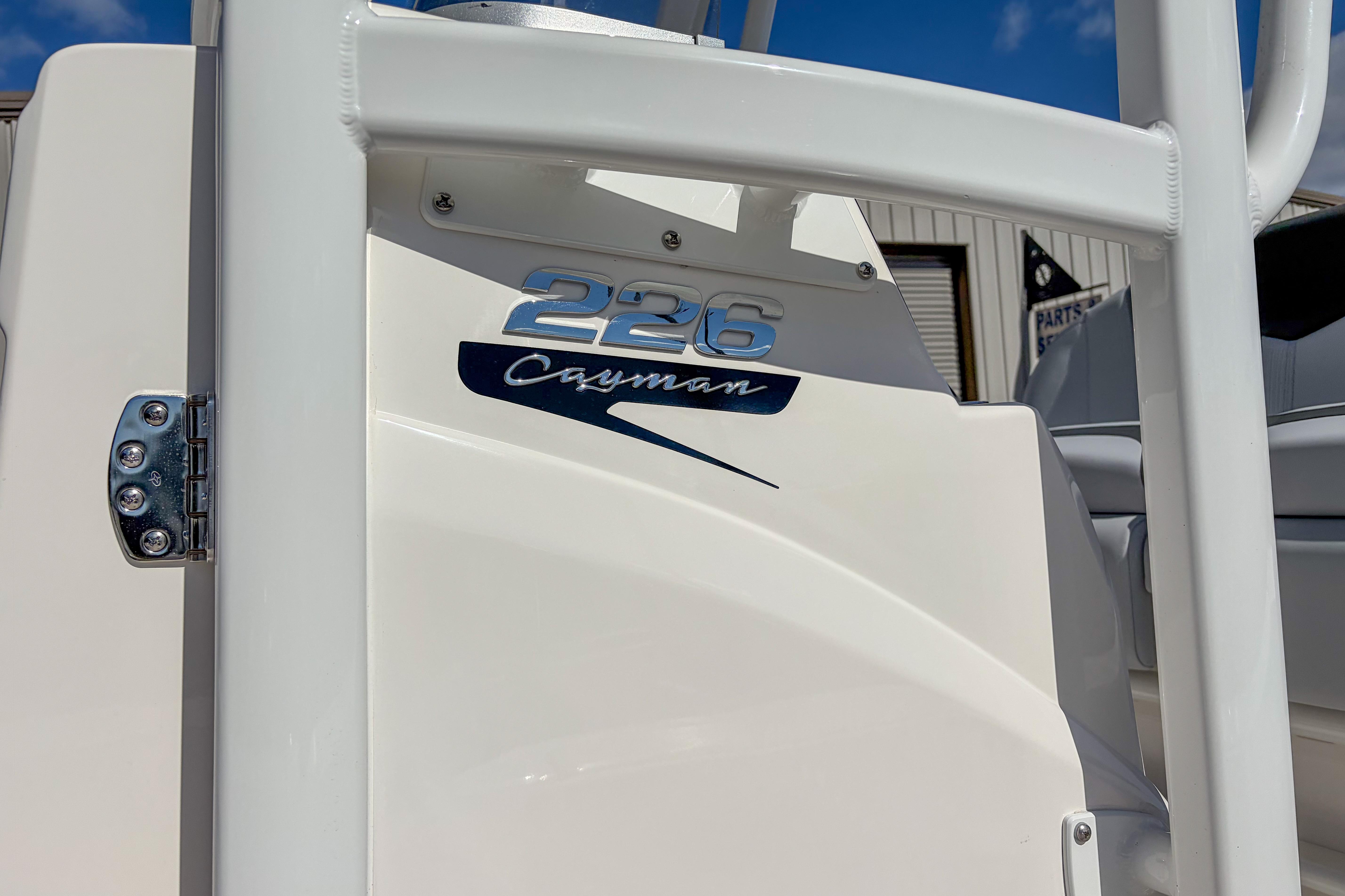 2025 Robalo 226 Cayman boat detail with logo and hinge in sunlight.
