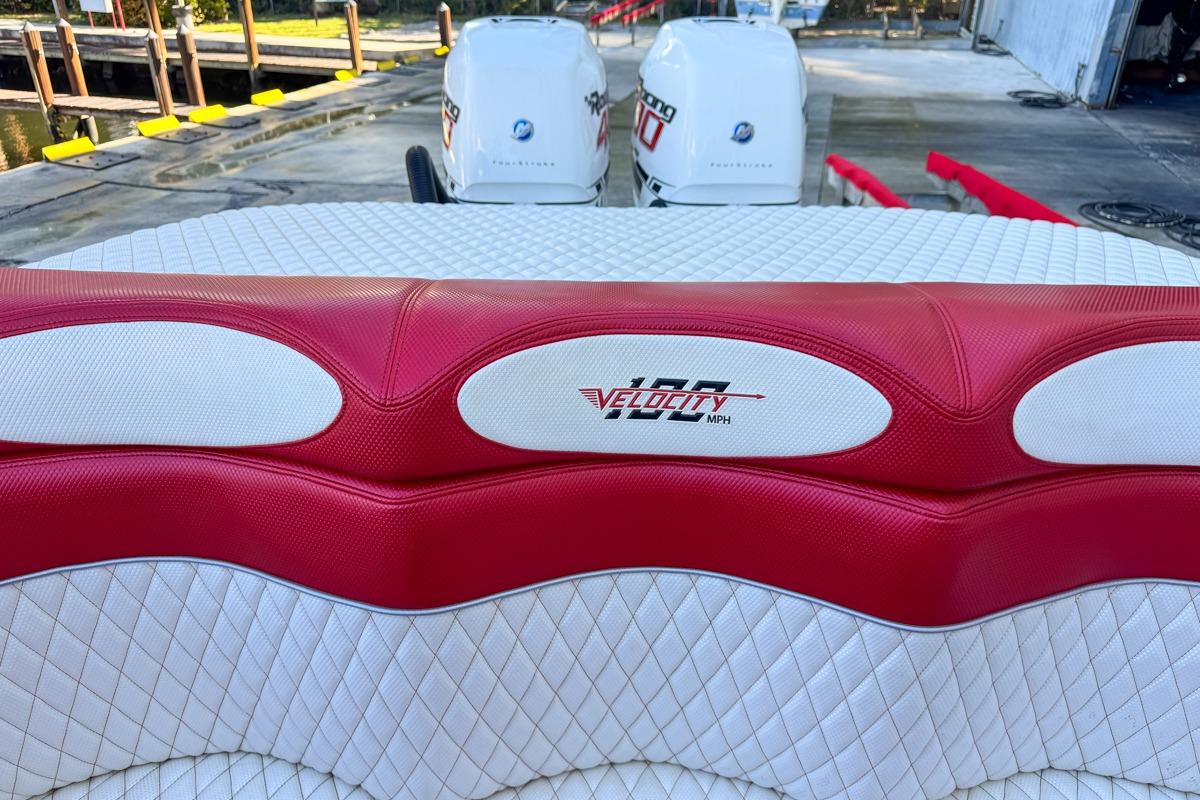 Red and white seating on 2022 Velocity 290sc boat with twin engines.
