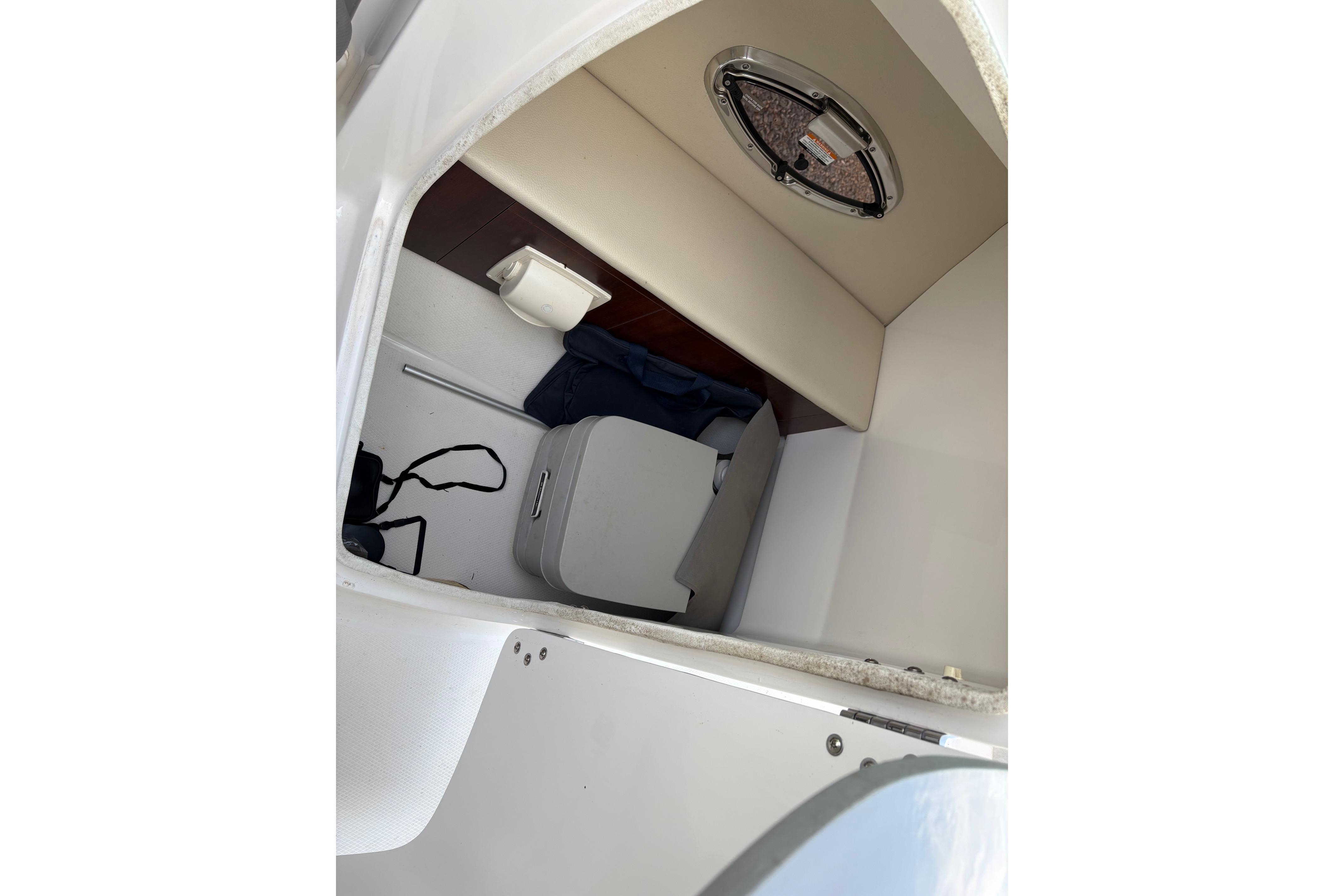 Interior cabin of 2016 Chaparral 246 SSi boat with seating and storage.