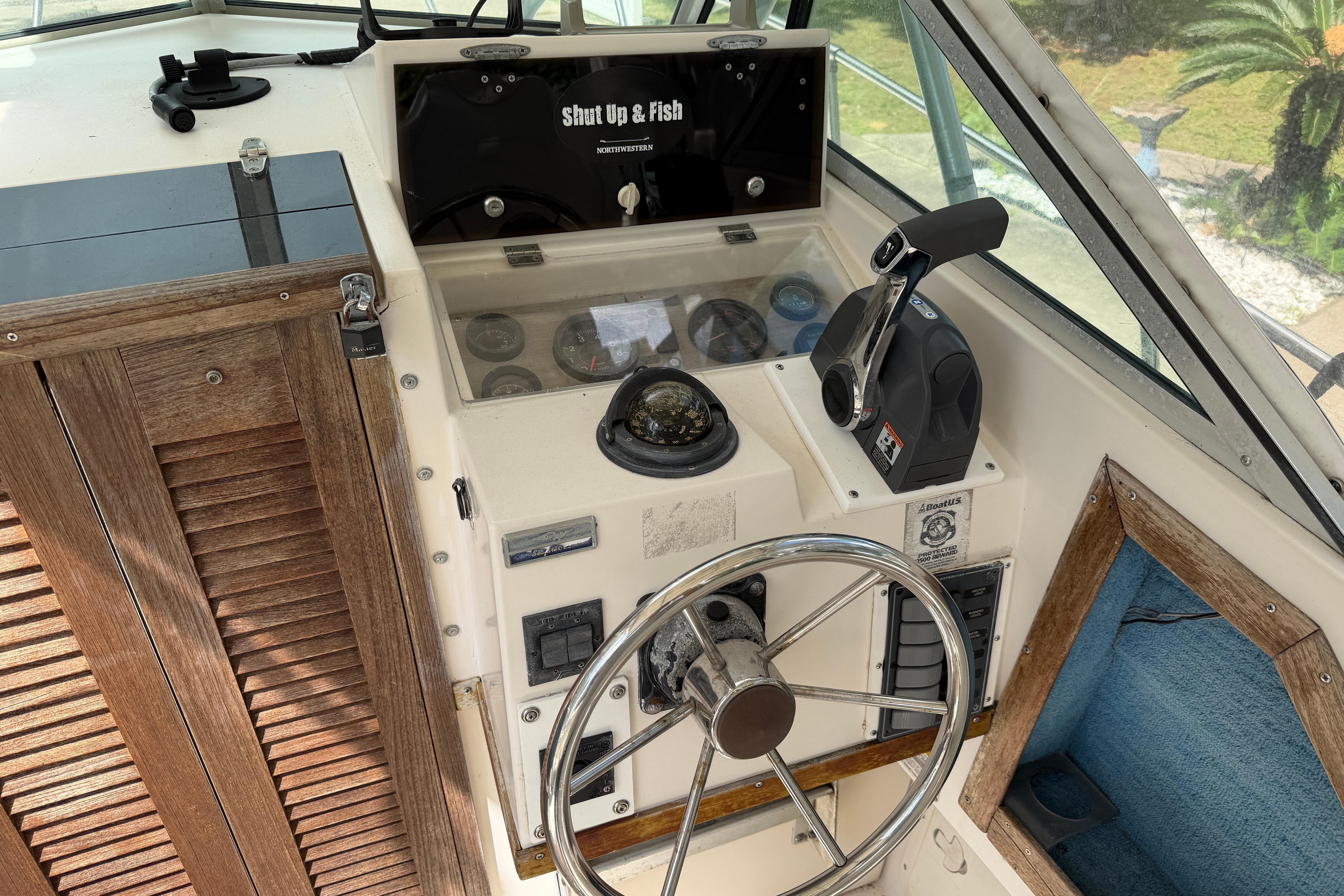 1987 Grady-White Seafarer 226 boat helm with steering wheel and control panel.