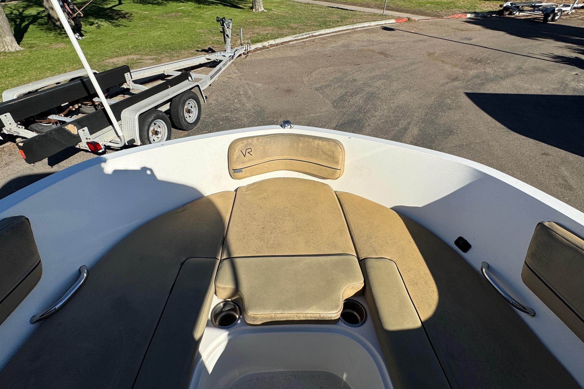 2022 Bayliner VR6 Bowrider OB interior with tan seating and cup holders.