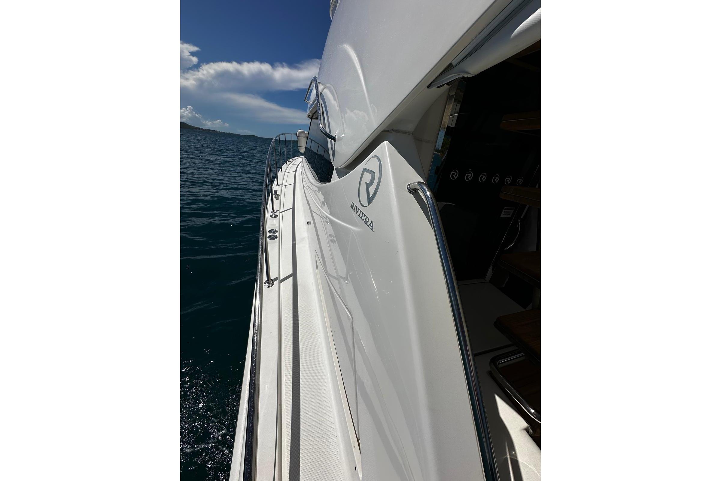 2012 Riviera 43 Flybridge yacht on open water, showcasing sleek design and luxury features.