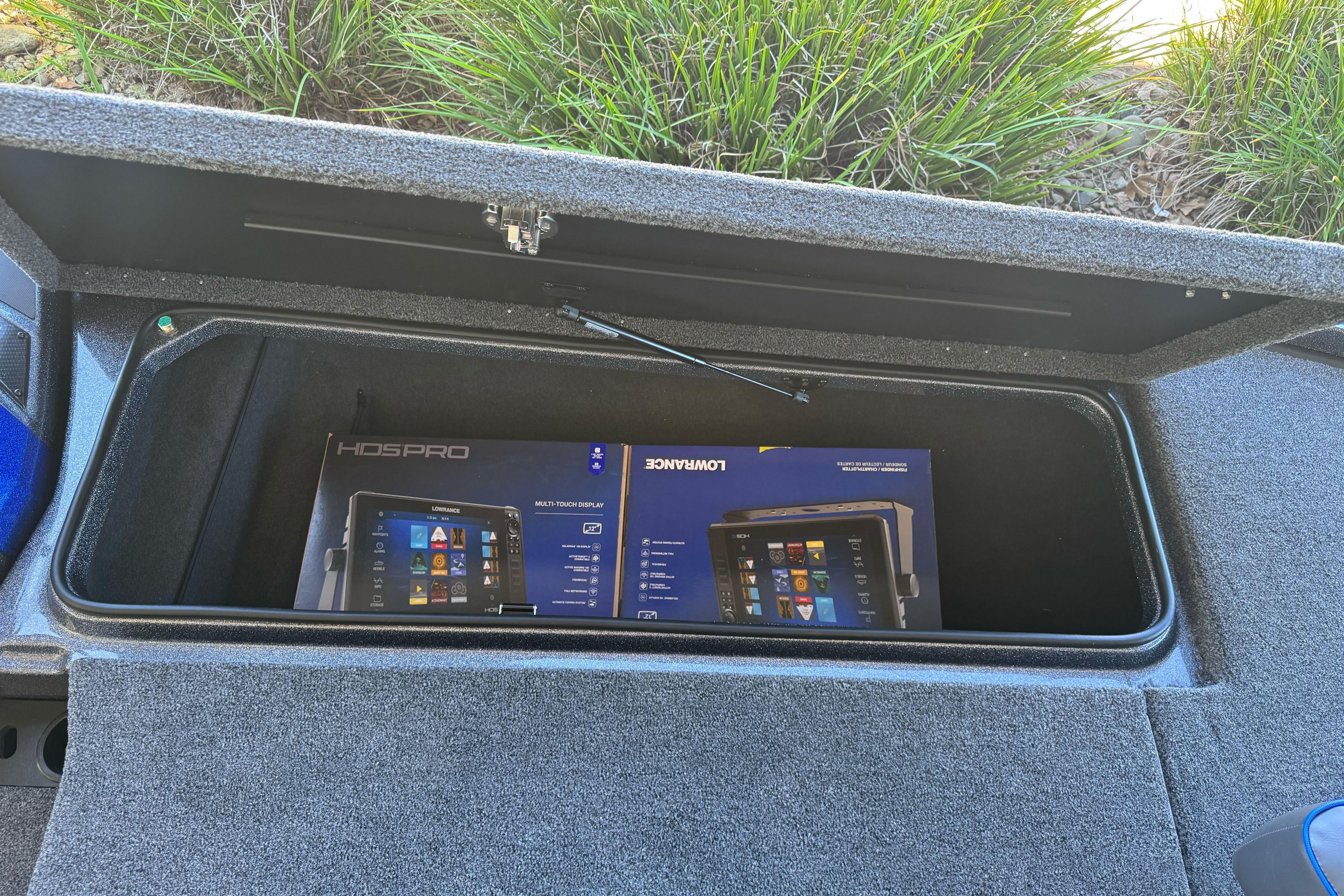 Storage compartment of 2026 Triton 21XP Patriot boat with Lowrance HDS Pro box inside.