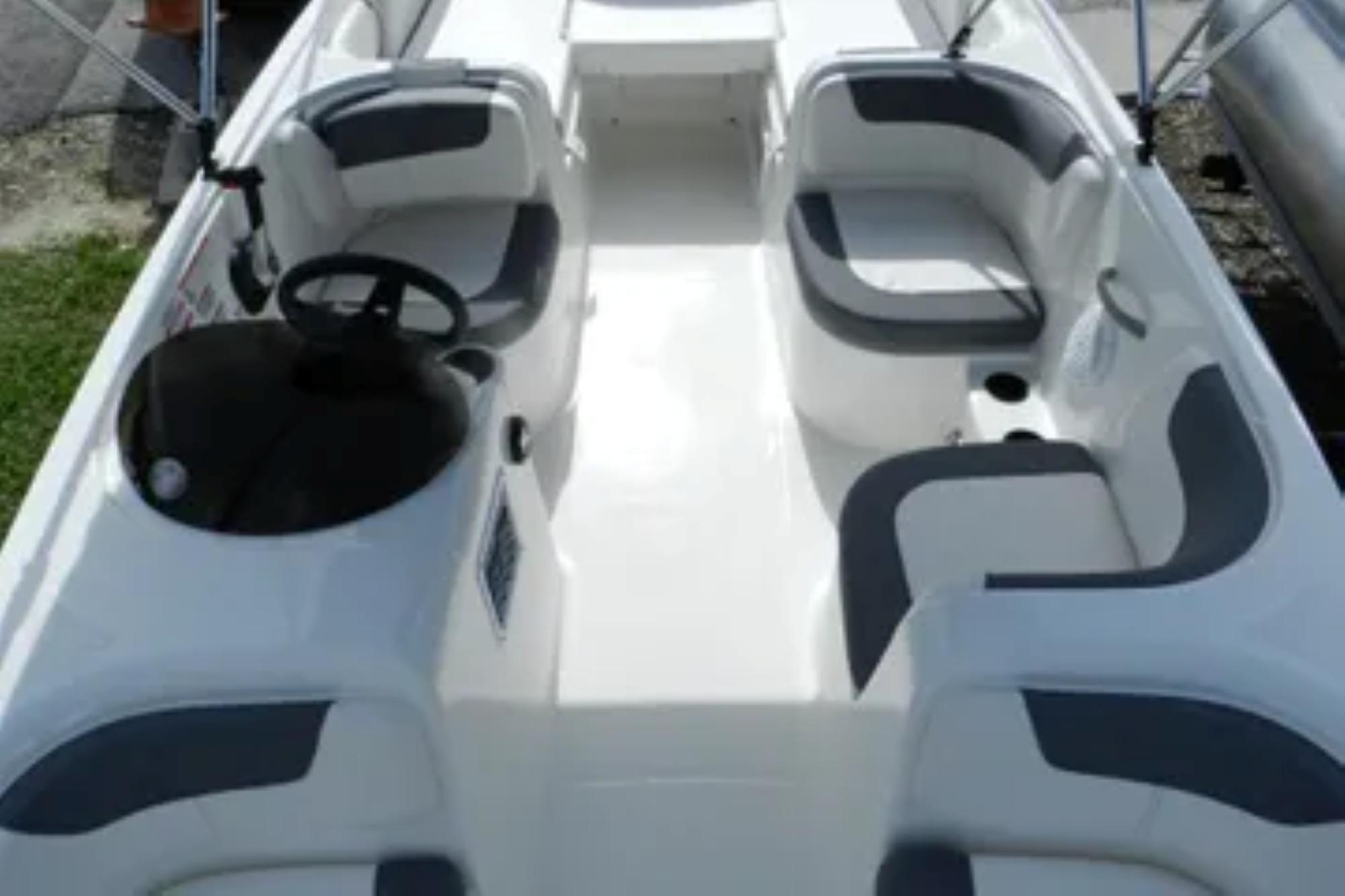 2026 Bayliner Element E18 boat interior with seating and steering wheel.