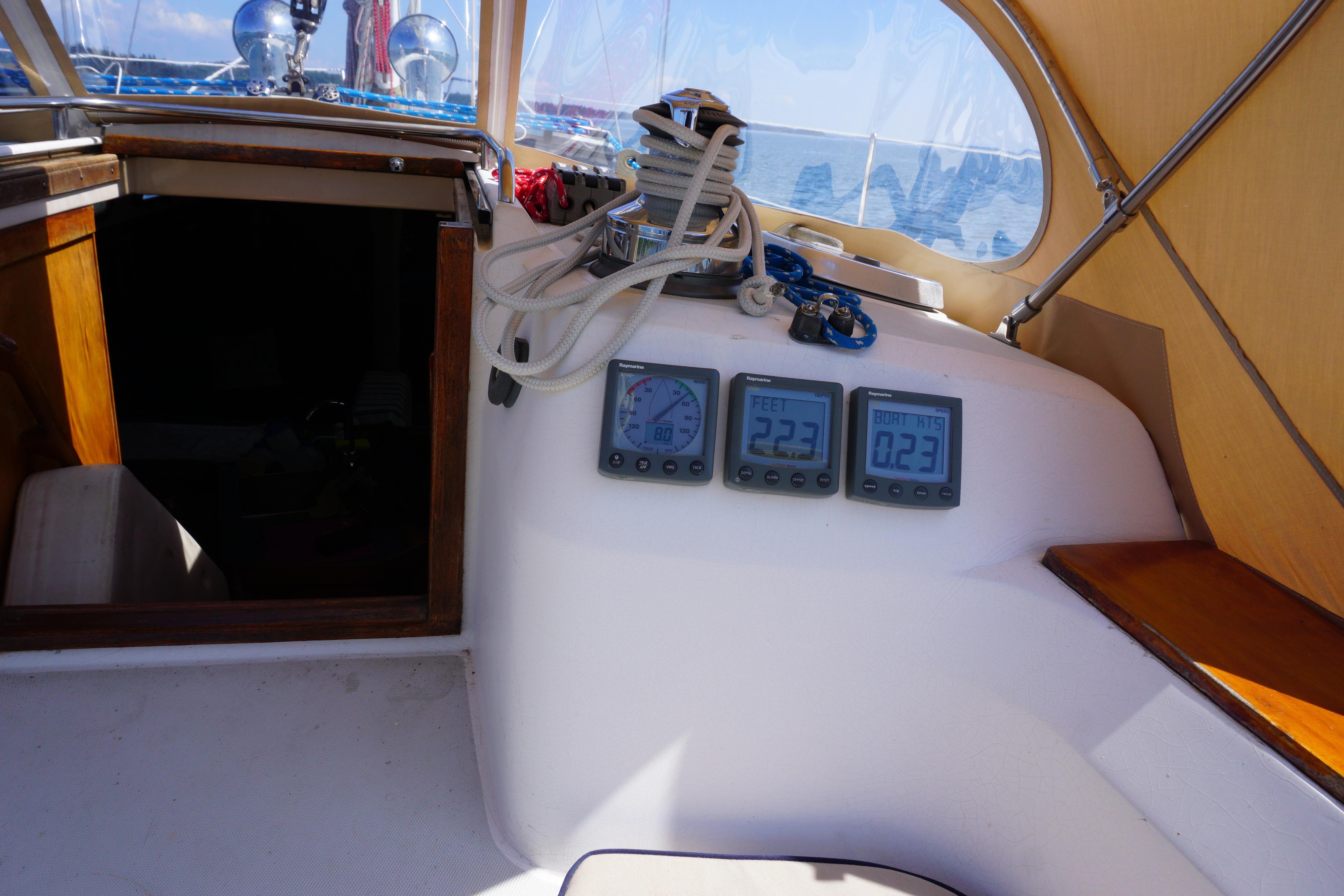 Cockpit of 1998 Sabre 402 sailboat with navigation instruments and ropes.