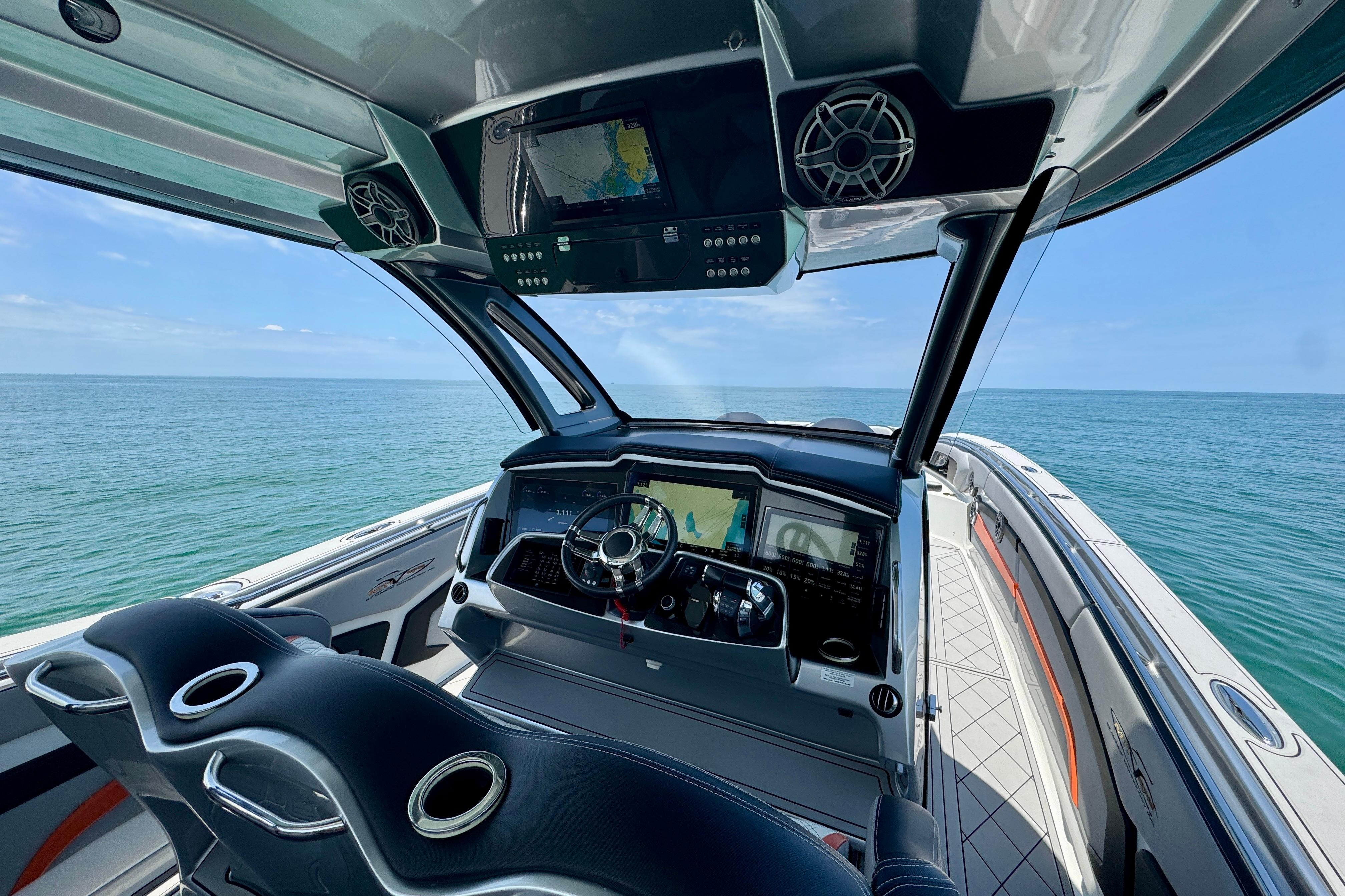 Cockpit view of 2017 MTI V42 boat with ocean backdrop and modern controls.