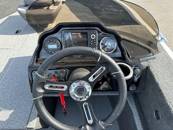 2024 Starweld 16 Fusion SC Pro boat dashboard with steering wheel and navigation controls.