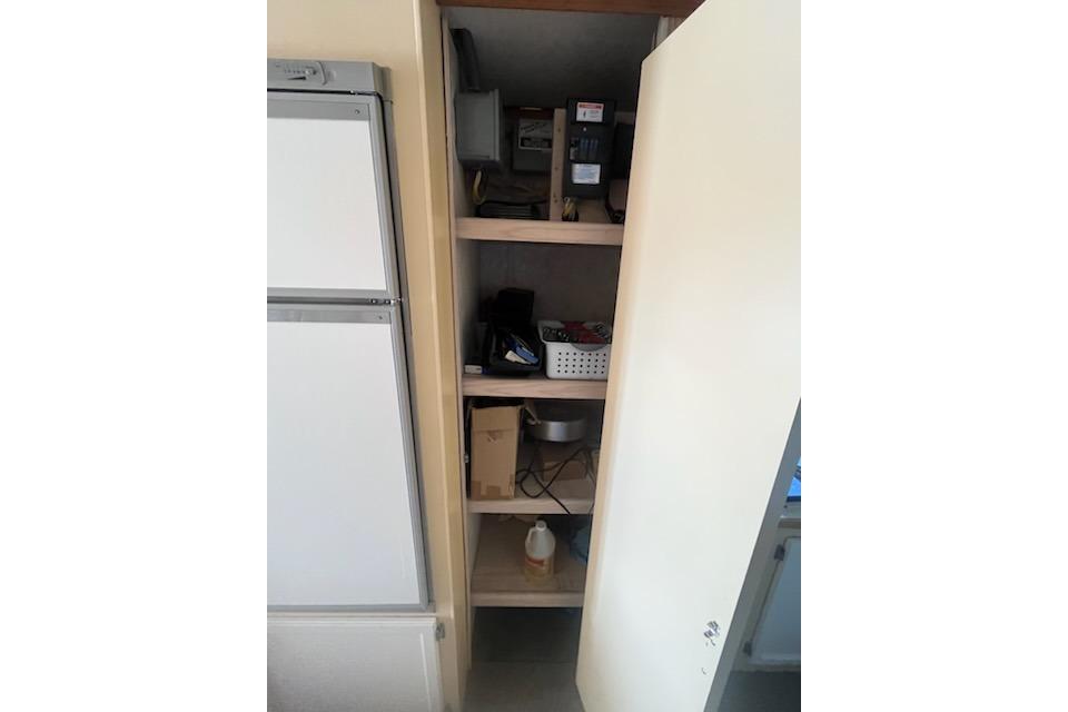 Storage cabinet with shelves inside a 1995 Myacht 40X13 houseboat.