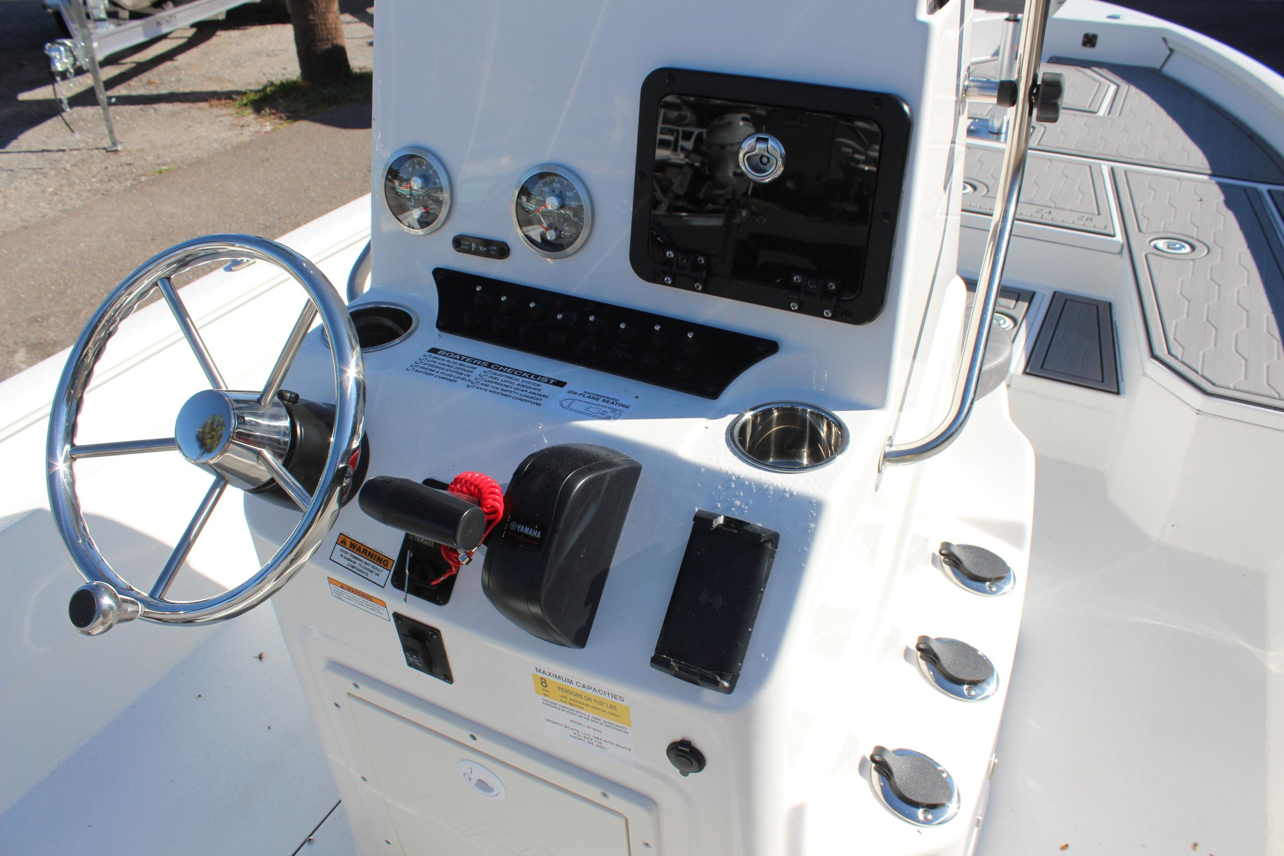 2023 Avid 21 Mag boat console with steering wheel and controls.