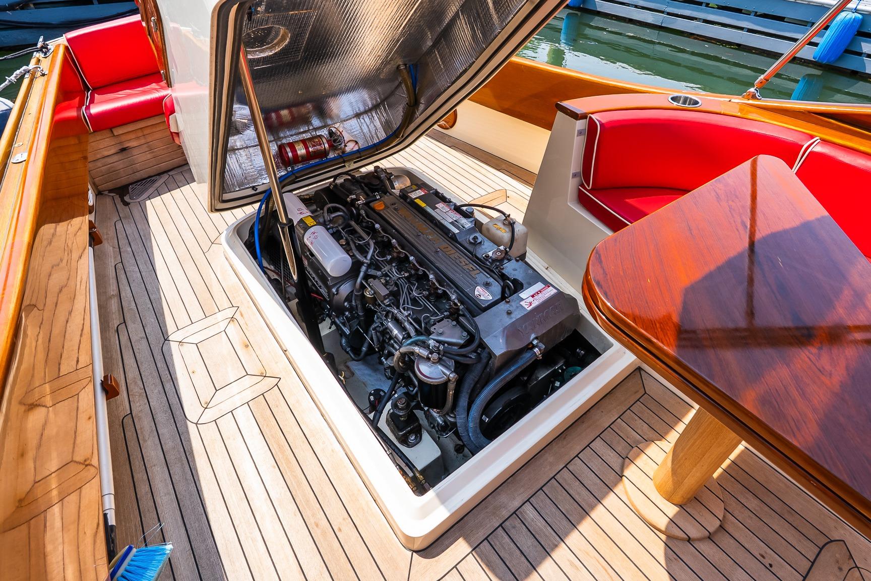 Engine compartment of 2005 Hinckley Talaria 29R with open hatch, showcasing interior details.