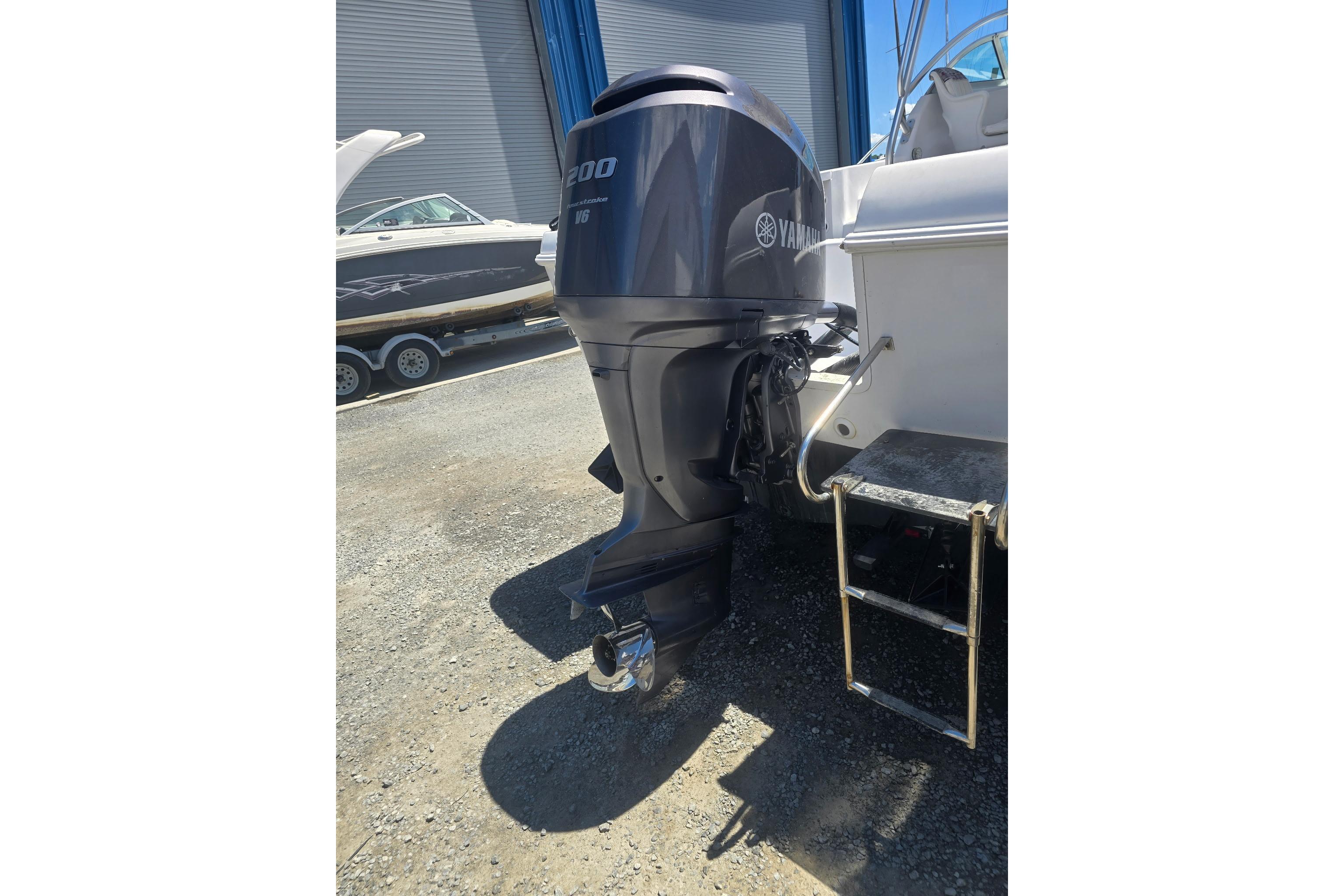 2003 Pro-Line 22 Walkaround boat with Yamaha outboard motor in a marina setting.