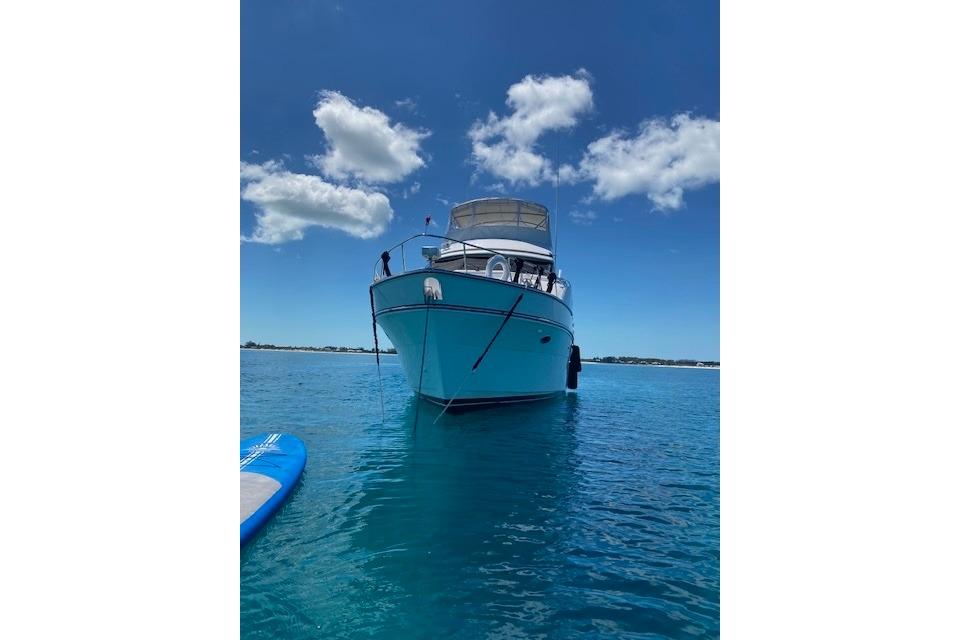 2007 Jefferson Pilothouse 52 SE yacht on clear blue water under a bright sky.