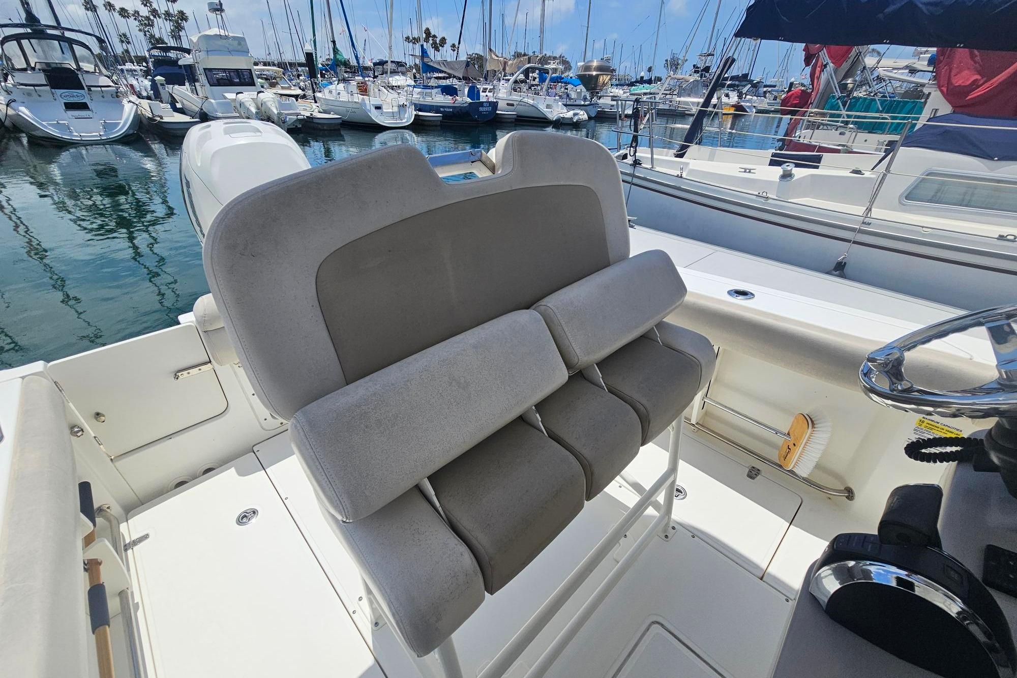 2017 Boston Whaler 230 Outrage boat interior with seating, docked at marina.