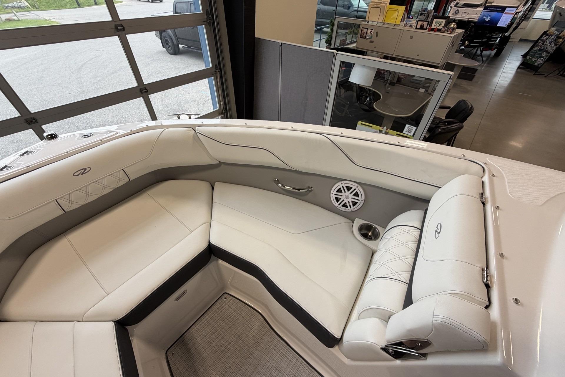 Luxurious interior of 2027 Regal LS2 boat with white seating and speaker system.