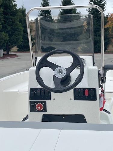 2025 Mako Pro Skiff 17 CC boat console with steering wheel and controls.