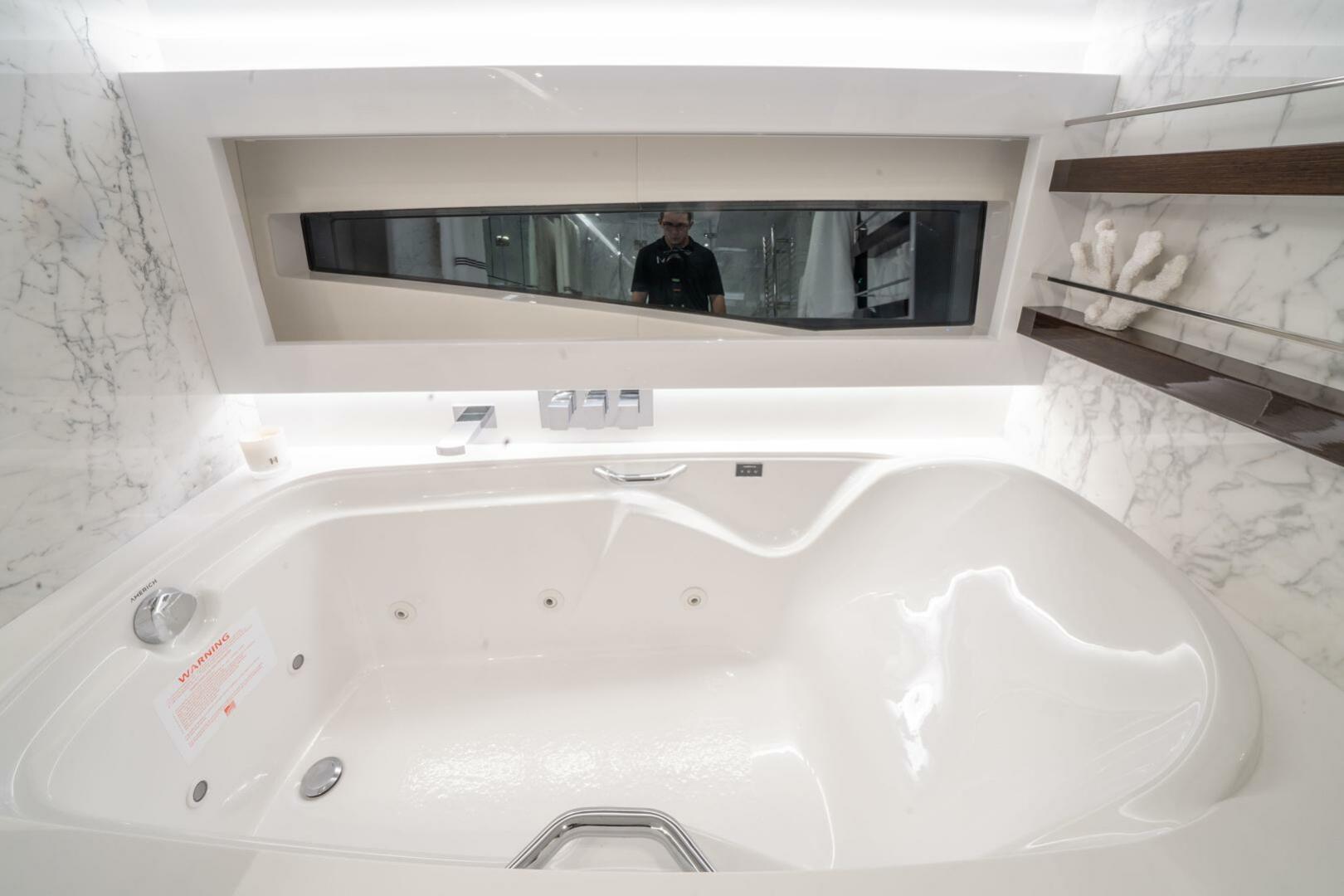 Luxurious Pearl 95 yacht bathroom with marble accents and modern bathtub, 2020 model.