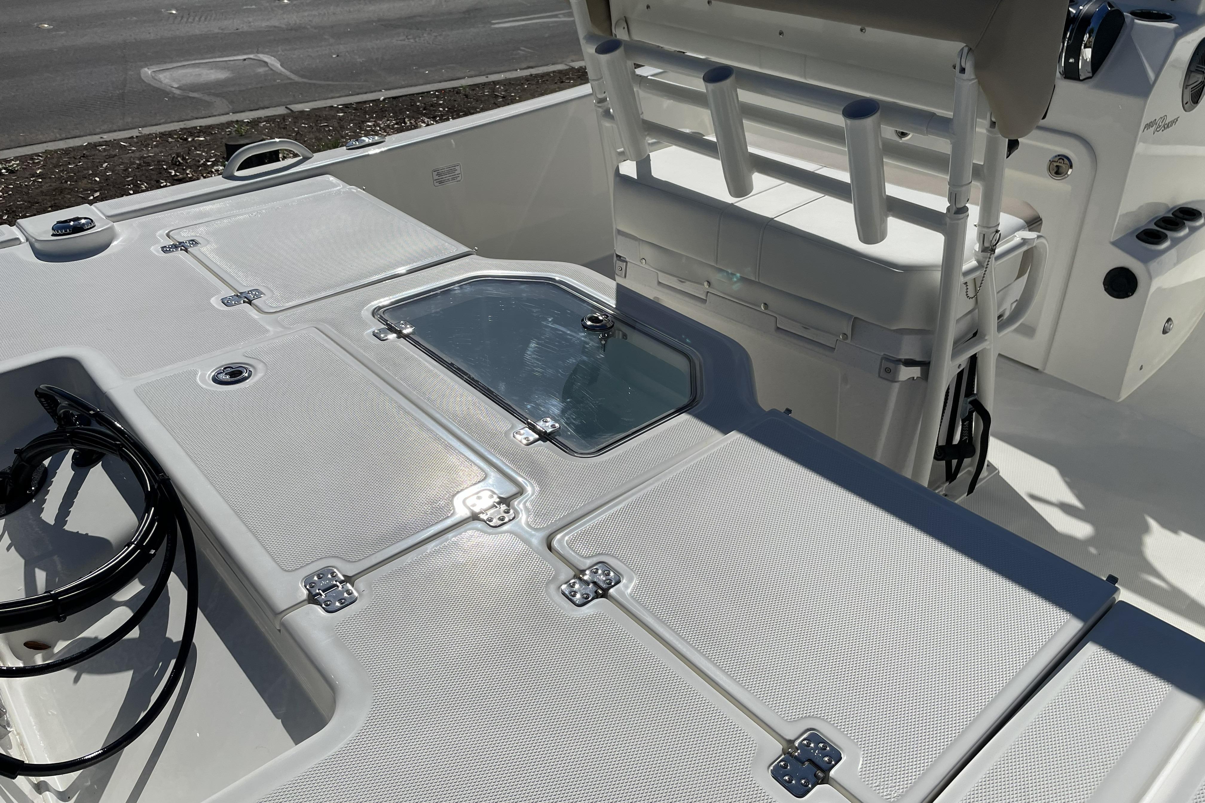 2026 Mako Pro Skiff 19 CC boat interior with storage compartments and seating.