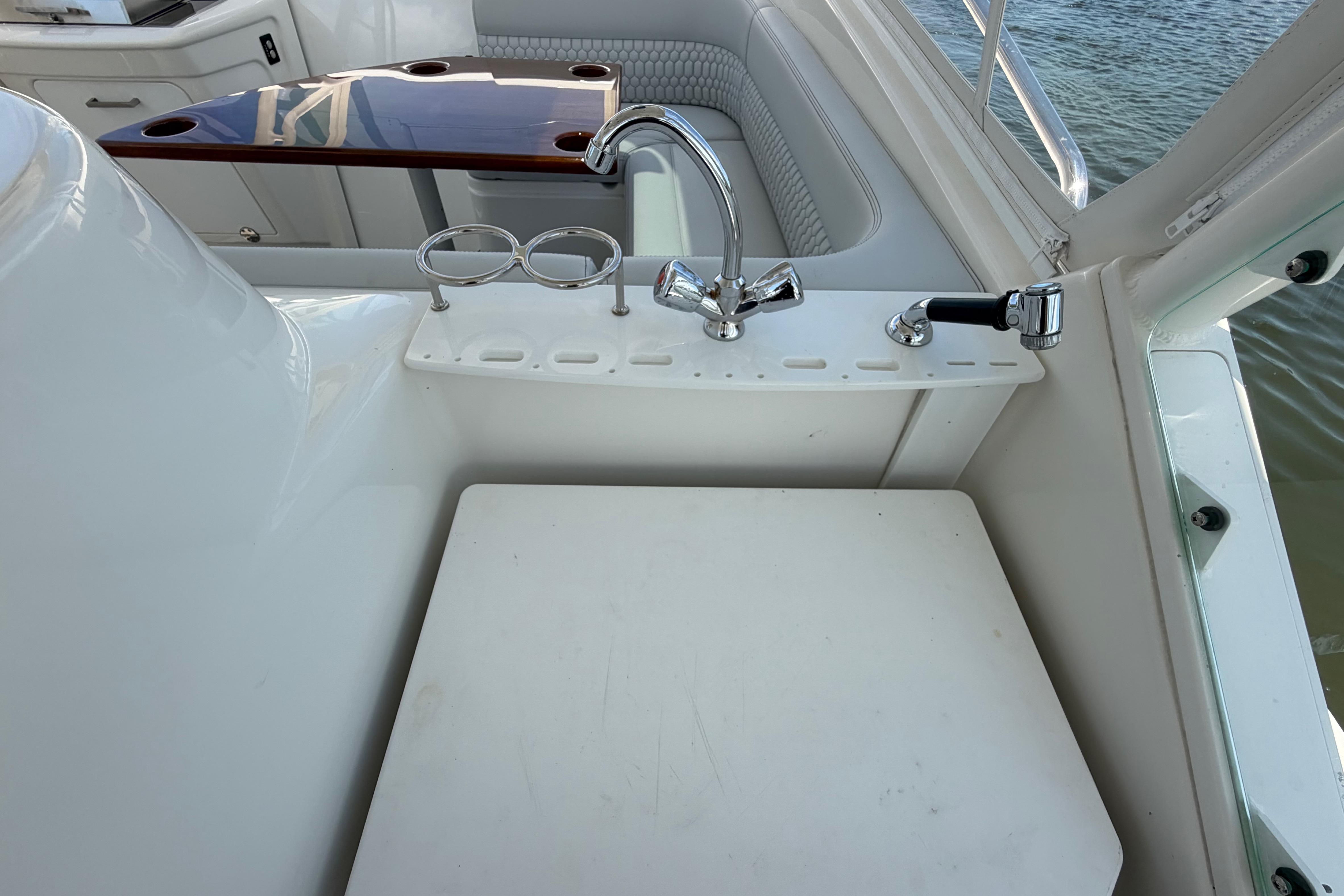 2009 Everglades 350LX boat interior with sink and seating area.