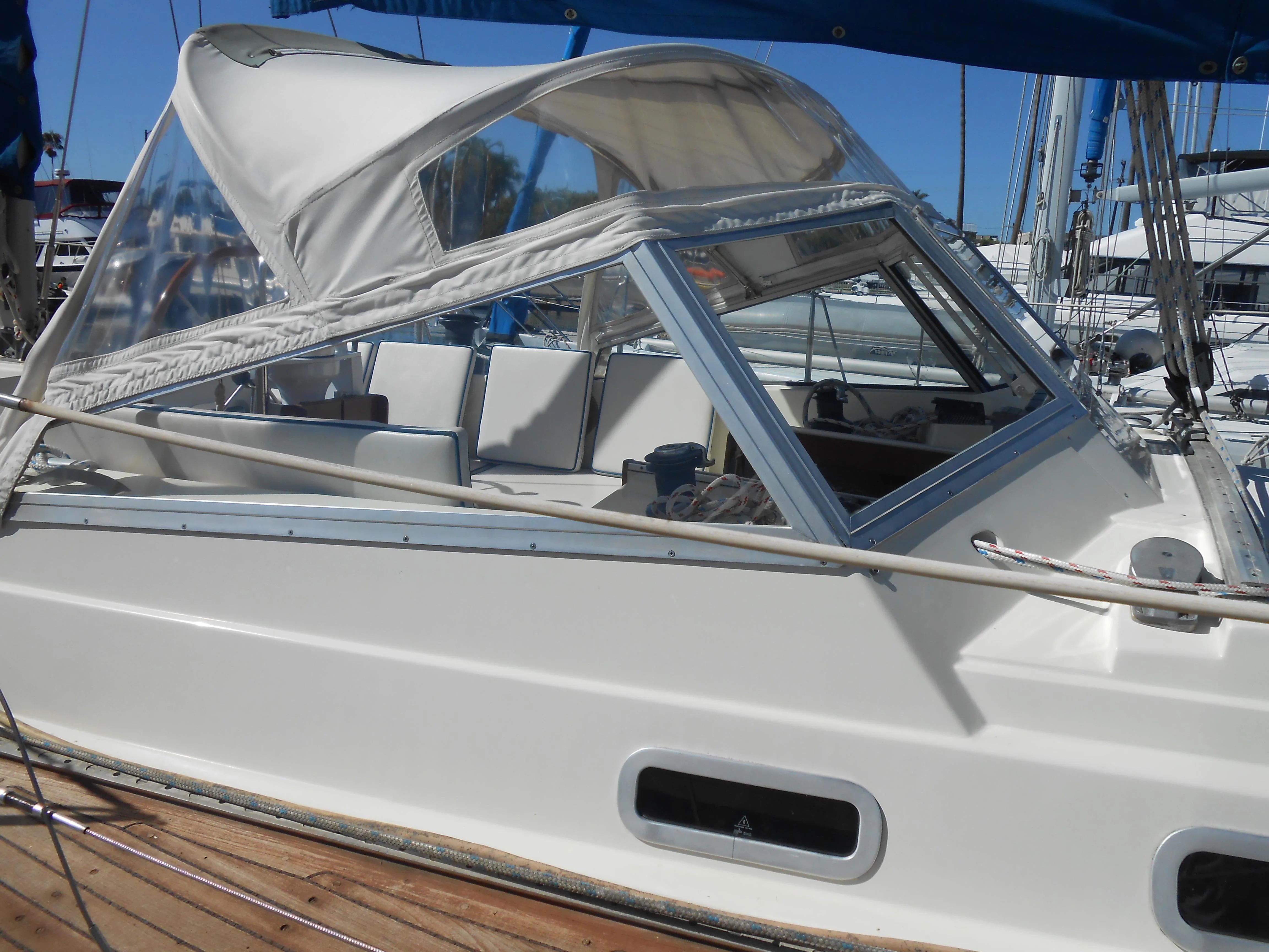 1985 Contest 41 Ketch with white canopy in harbor.