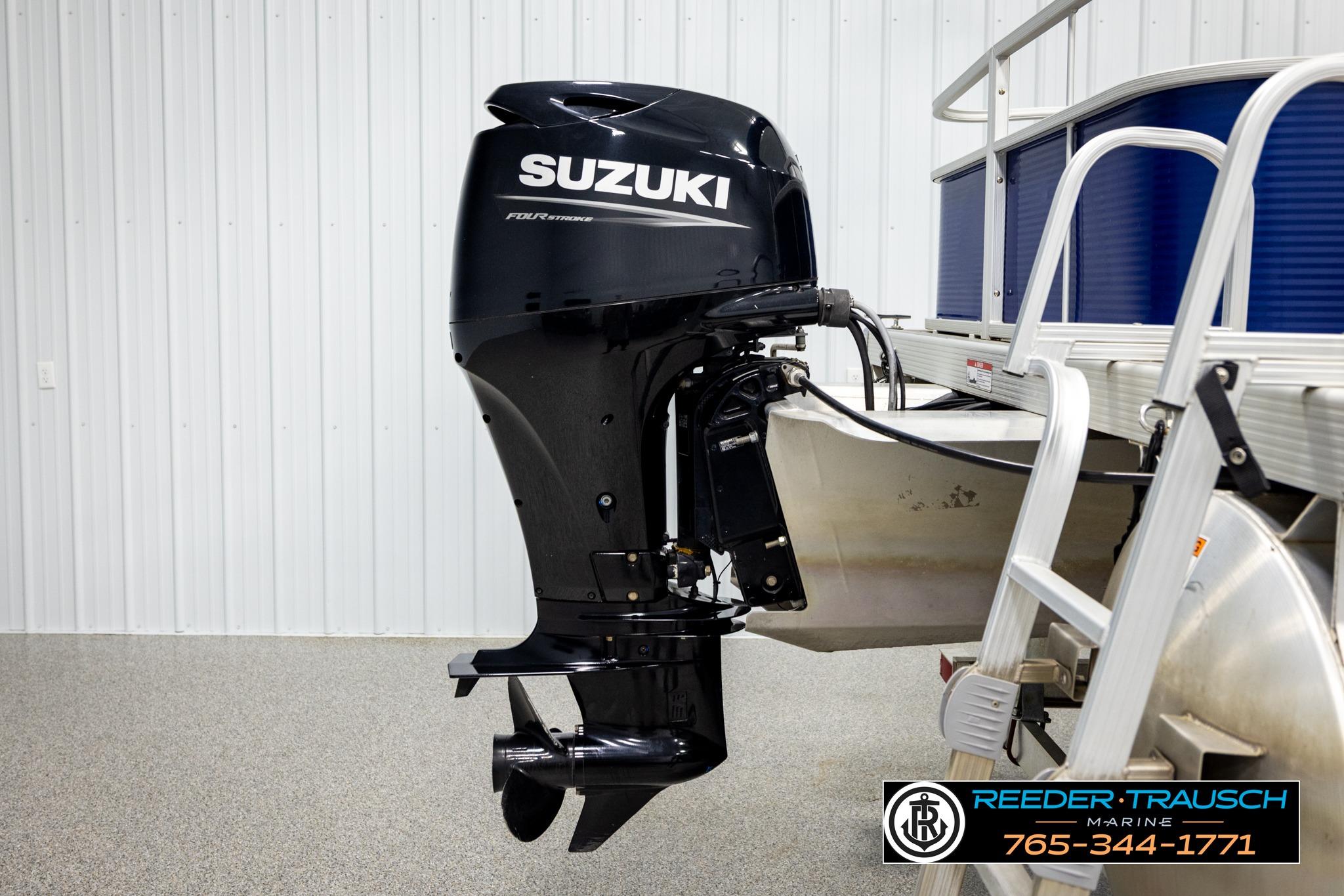 2021 Bennington 20 SV pontoon boat with Suzuki outboard motor in showroom.