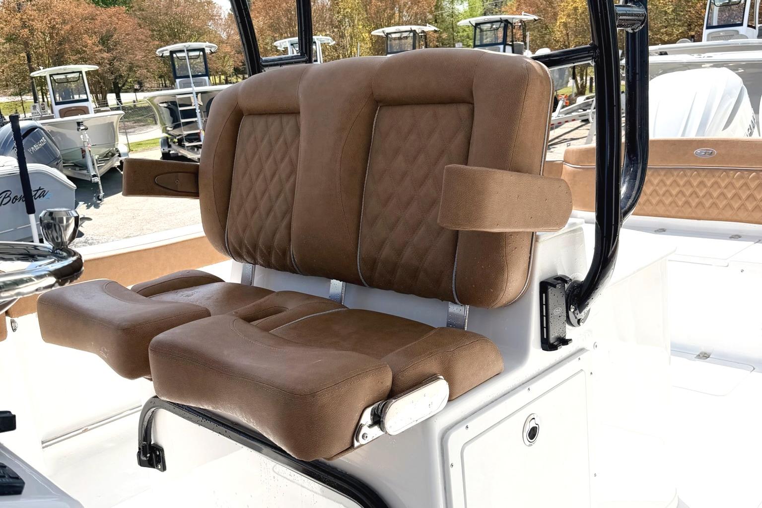 2026 Seahunt Ultra 305 CB boat with luxurious brown seating and armrests.