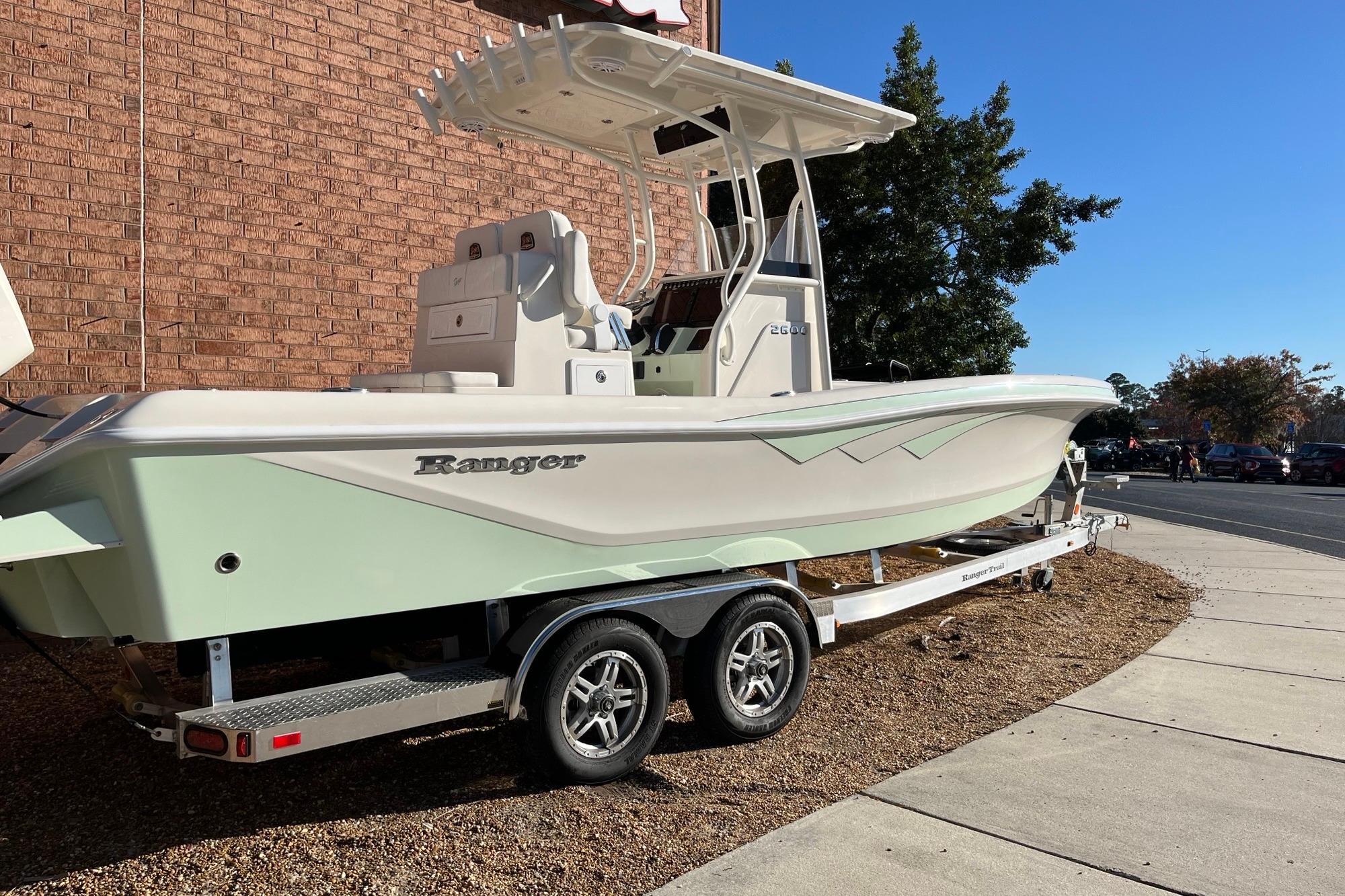 2024 Ranger 2600 Bay boat on trailer, parked outdoors near brick wall.