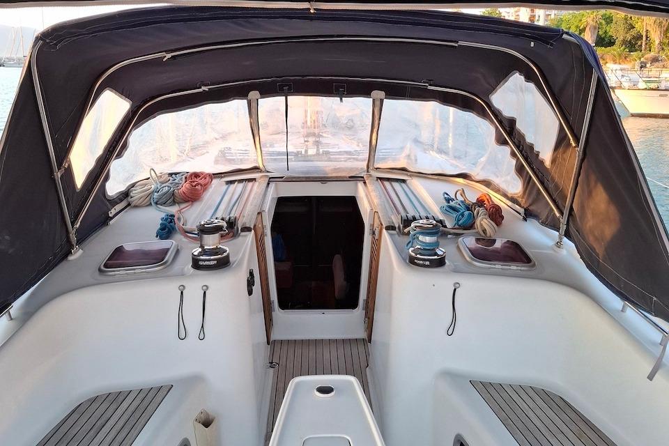 2009 Beneteau Oceanis 54 cockpit with ropes and winches, sheltered by a canopy.